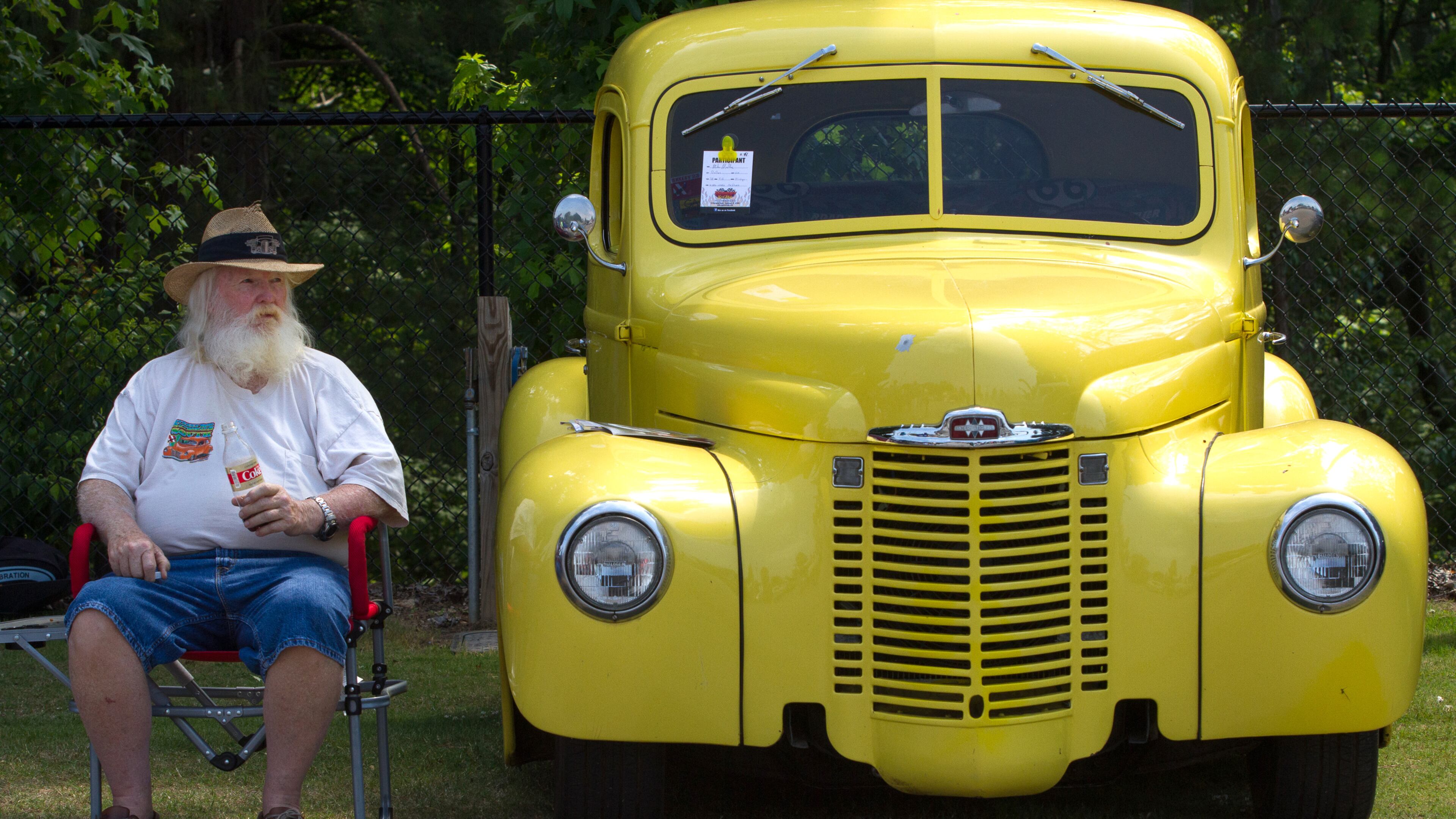 Mike Medley sits next to his 1948 international truck during the 28th annual Creepers Car Show at Jim R. Miller Park in Marietta on Saturday.