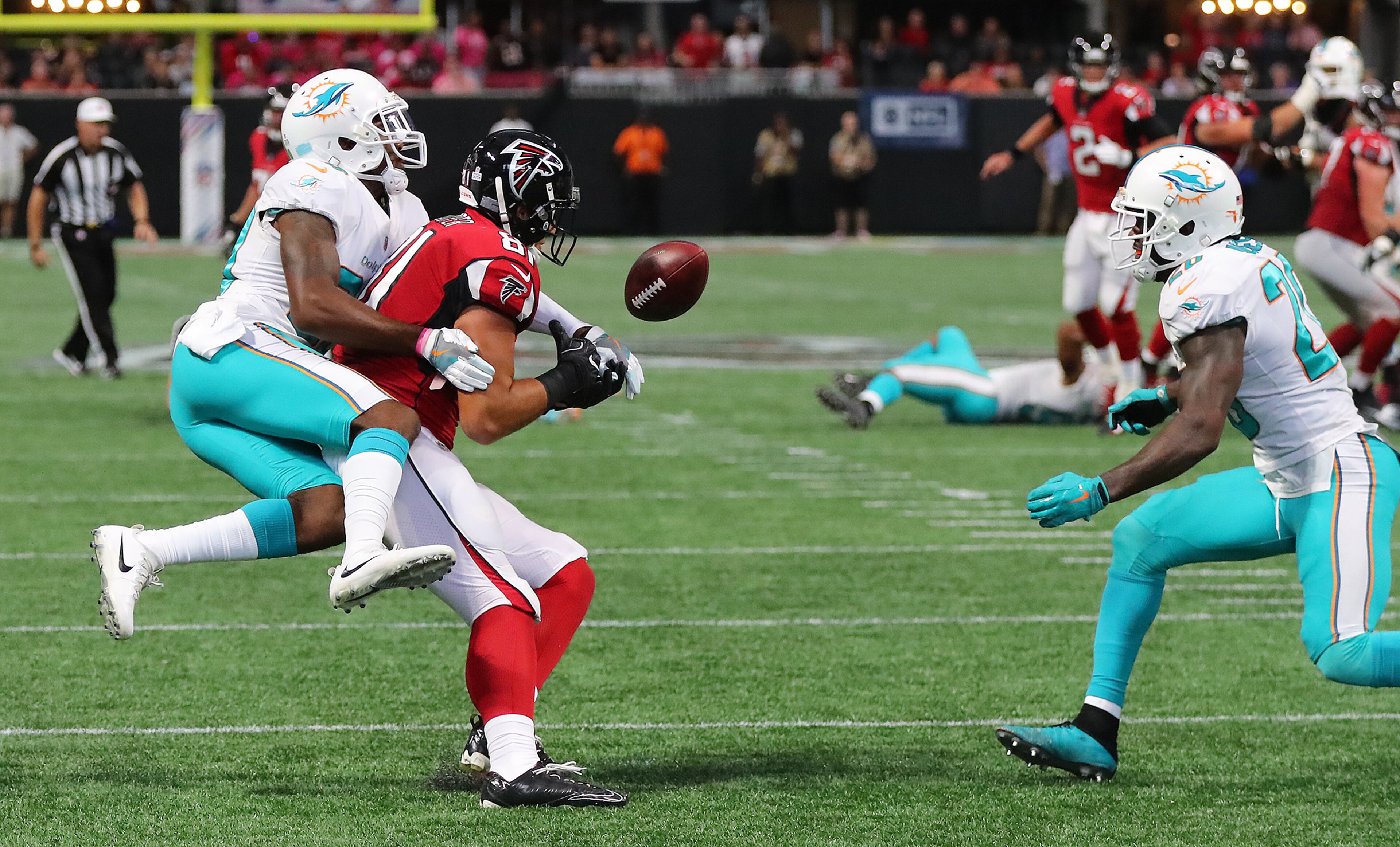 Dolphins cornerback Cordrea Tankersley knocks the ball away from Falcons tight end Austin Hooper and into the arms of Dolphins safety Reshad Jones in the final minute of the Falcons' 20-17 loss at home Oct. 15. Curtis Compton/ccompton@ajc.com.