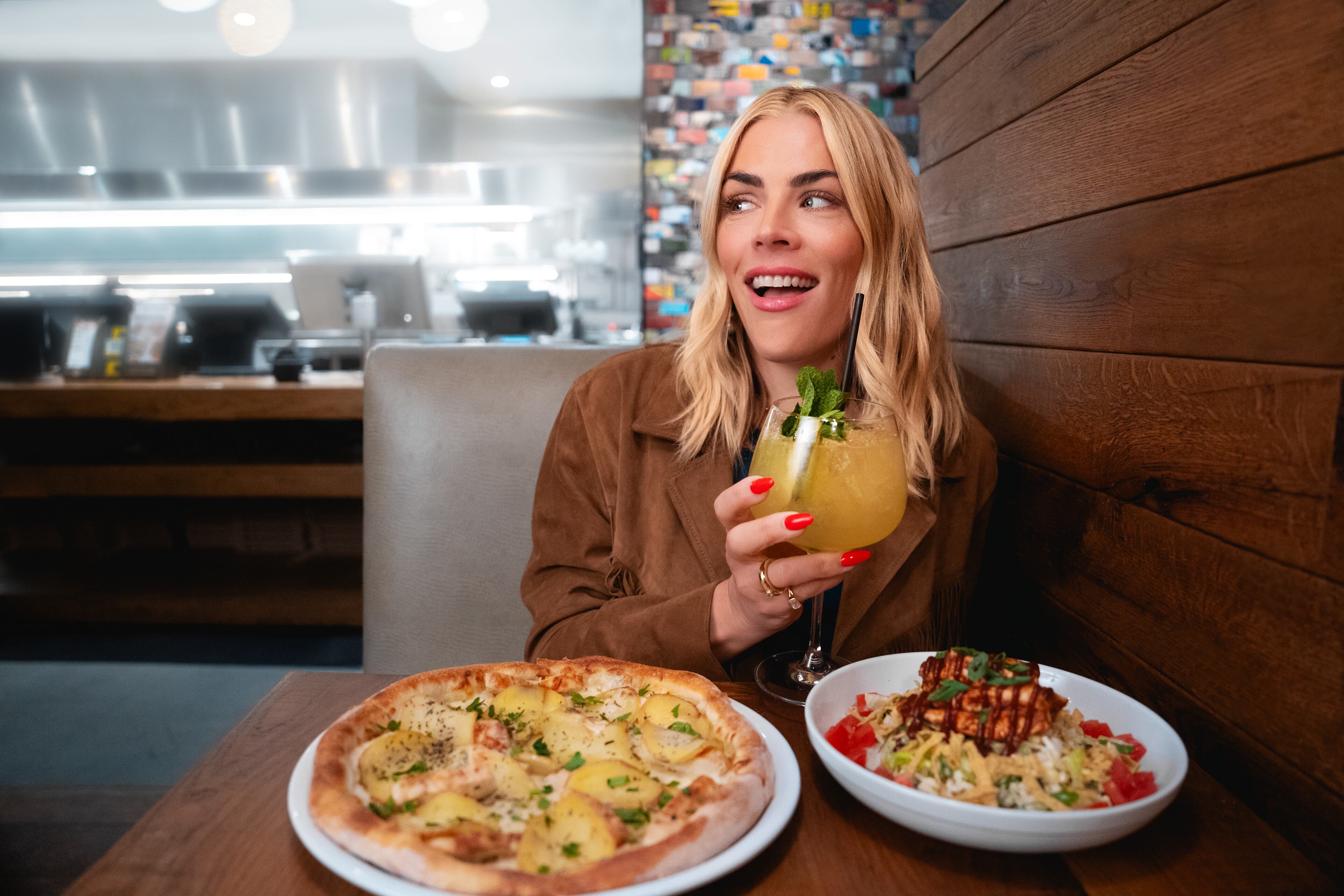 Actor Busy Phillips is promoting the 40th anniversary menu at California Pizza Kitchen, the chain restaurant where she once worked as a hostess. March 28, 2025 (Courtesy of California Pizza Kitchen)
