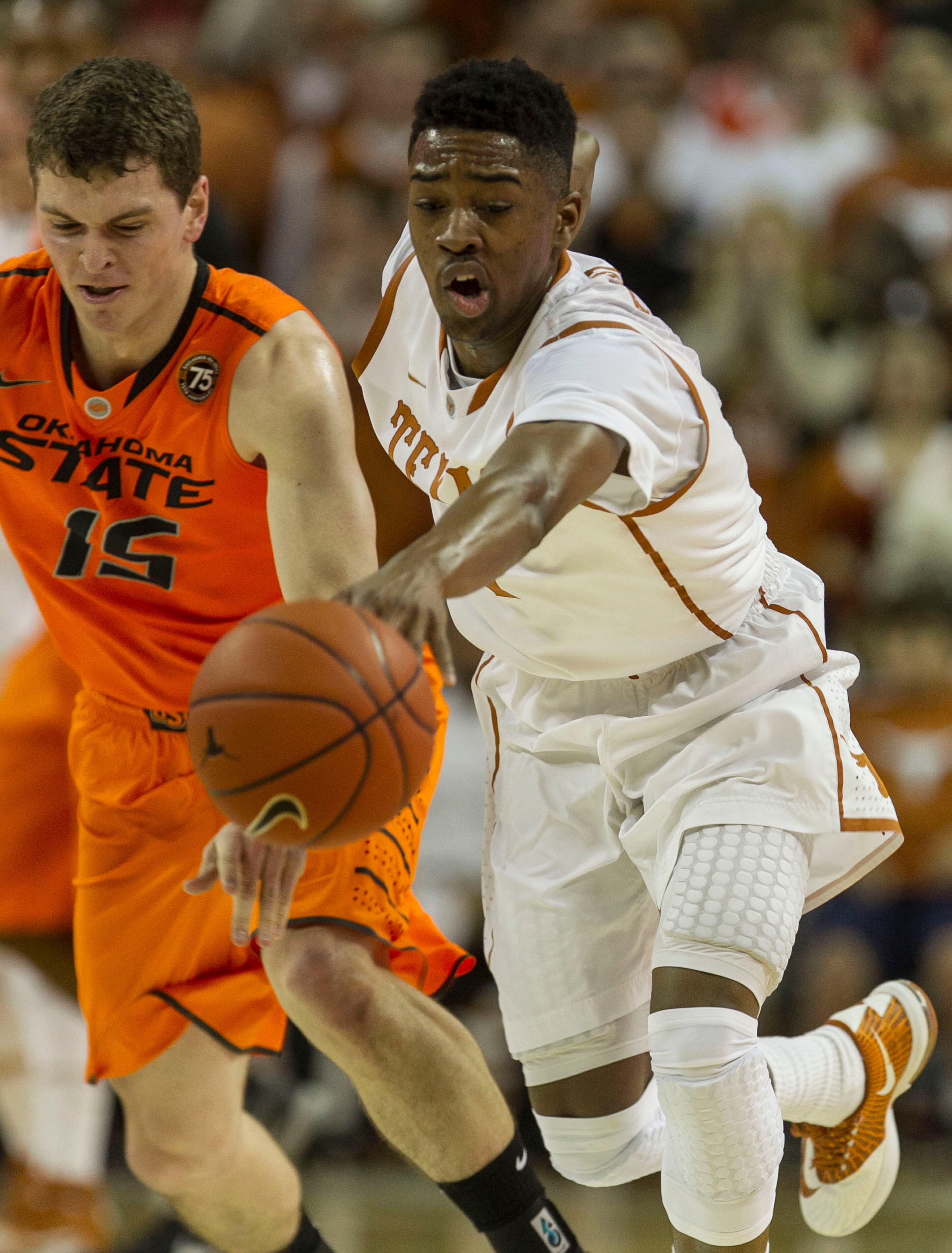 Texas #1, Isaiah Taylor, right, gets the steal against Oklahoma State #15, Christien Sager, left, during the first half of Big 12 action held at the University of Texas Frank Erwin Center, in Austin, Texas, on Tuesday, February 11, 2014.