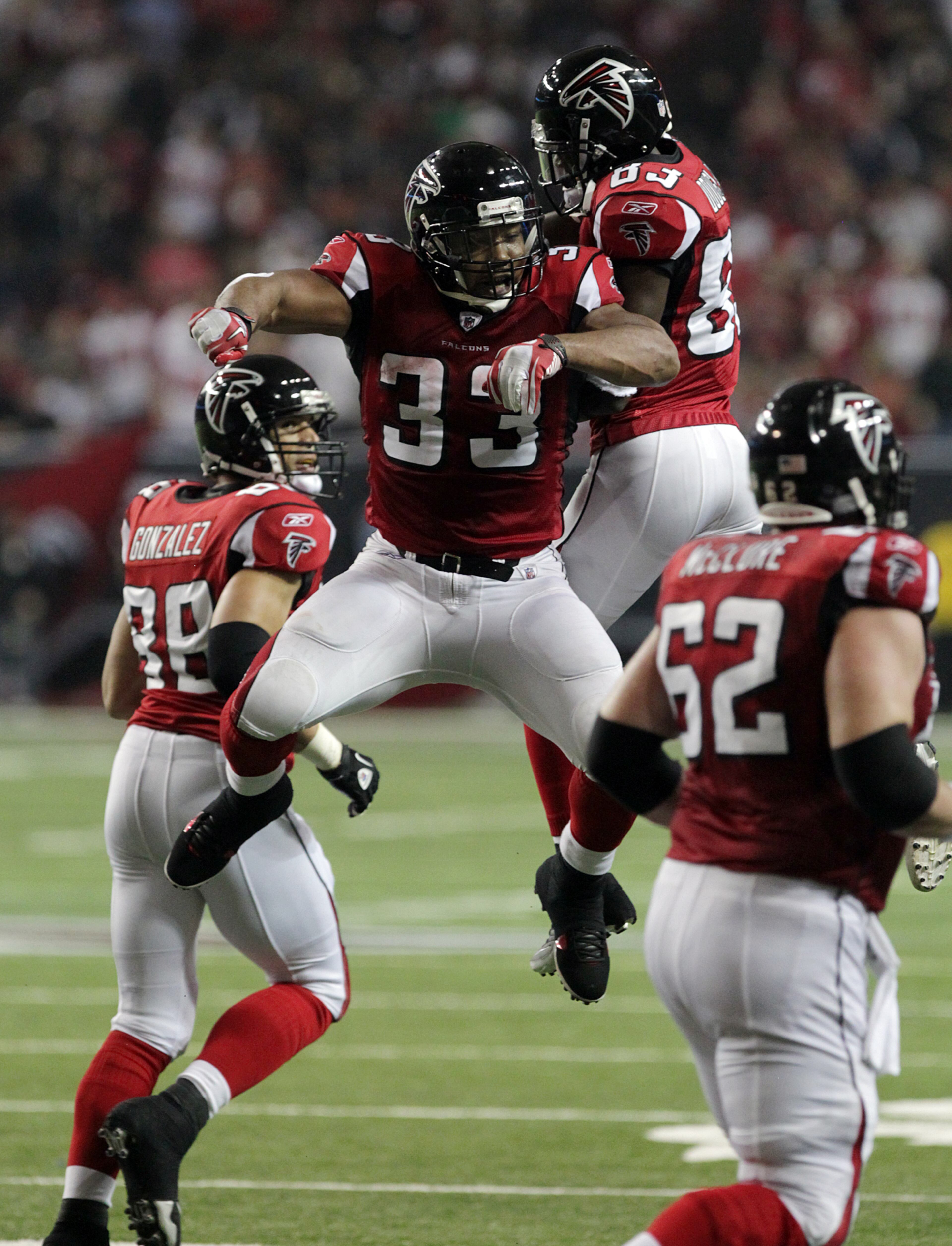 Dec. 15, 2011 - Atlanta: Atlanta Falcons running back (33) Michael Turner goes airborne to celebrate his touchdown run with Harry Douglas for a 17-0 lead over the Jaguars during 1st half action at the Georgia Dome in Atlanta on Thursday, Dec. 15, 2011. Curtis Compton ccompton@ajc.com