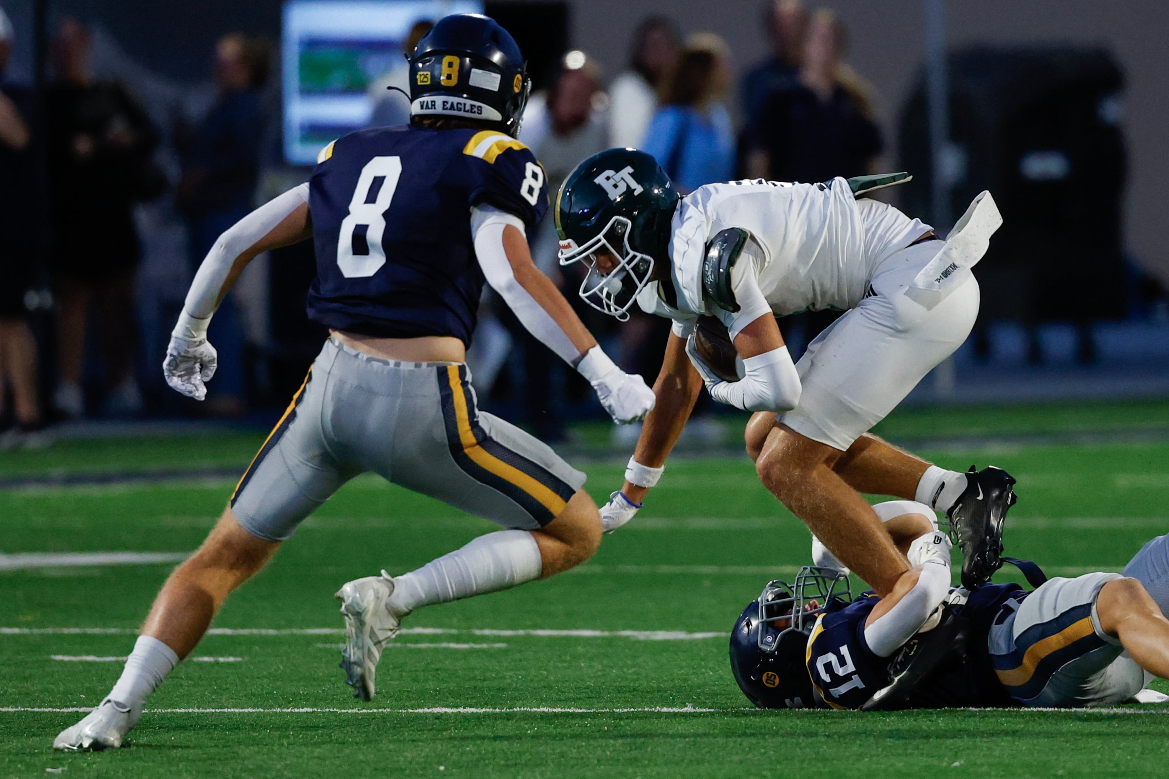 Marist's Jake McLaren (8) and Bobby Harpring (12) tackle Blessed Trinity's Quinn Smith (9) during the first half a high school football game between Blessed Trinity and Marist, Friday, Sept. 25, 2026, in Atlanta. (Erik S. Lesser for the AJC)