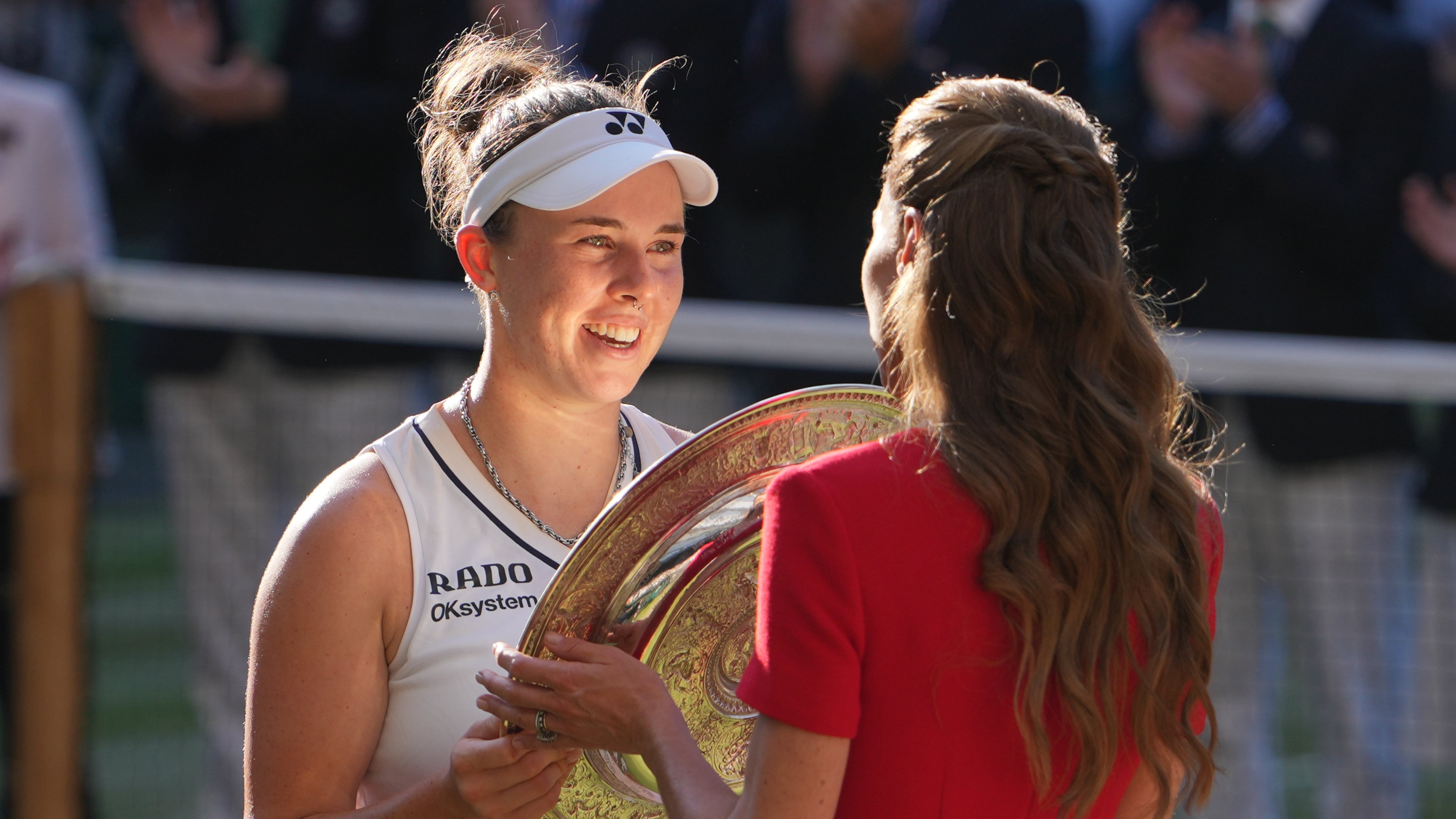 Linda Noskova of Czech Republic receives the champion trophy from Britain's Princess Kate after defeating Karolina Muchova of Czech Republic the women's singles final at Wimbledon Tennis Championships in London, Saturday, July 11, 2026. (AP Photo/Kin Cheung)