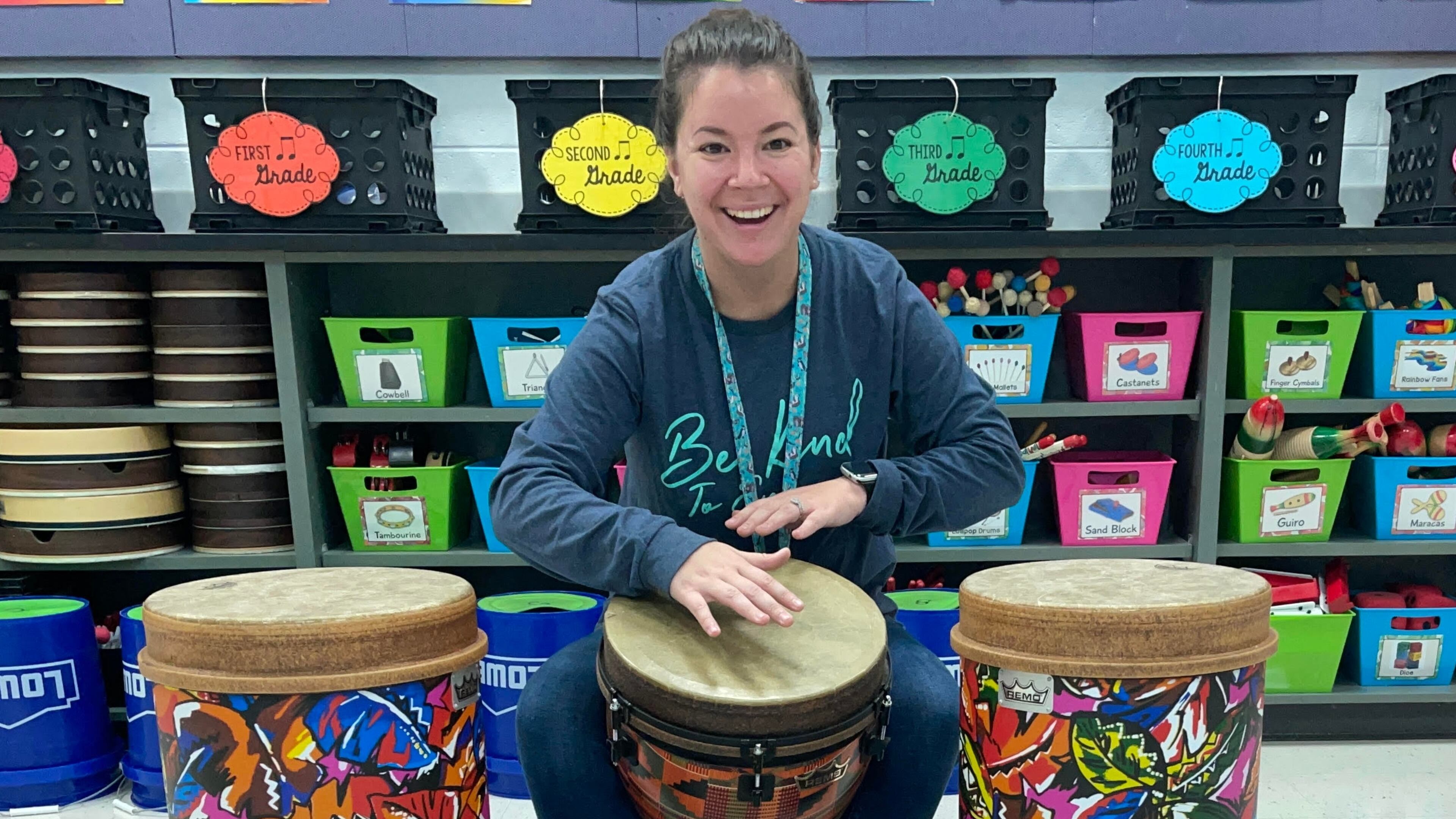 Ocee Elementary music teacher Damarys Klausman is flanked by two tubano drums. A recent grant will add more of the tall instruments to her classroom.