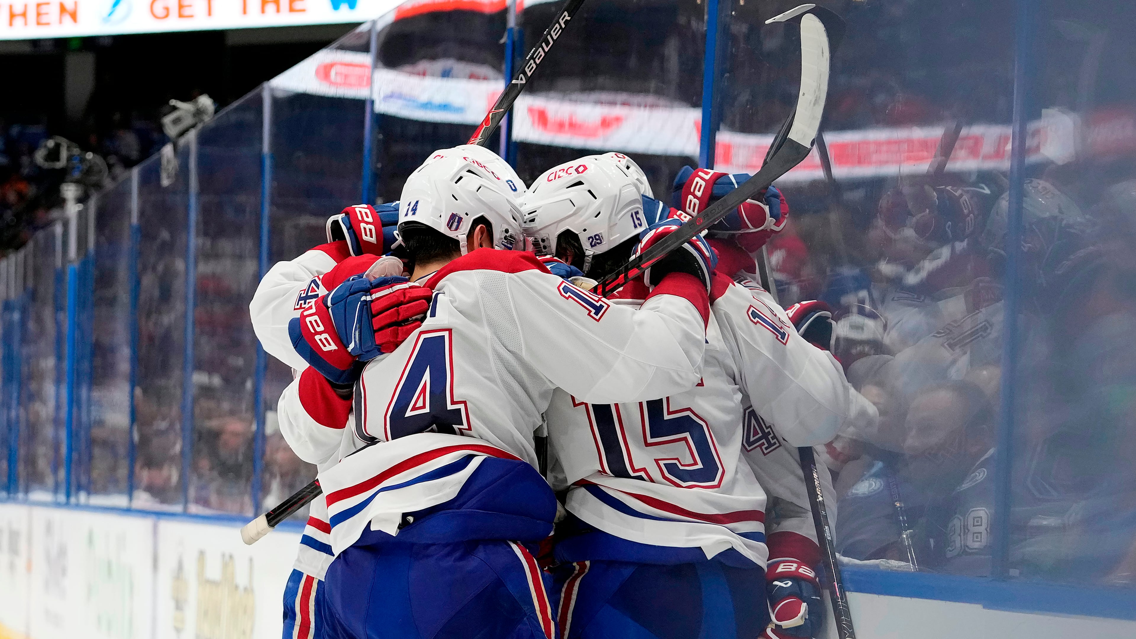 Montréal Canadiens center Alex Newhook (15) is mobbed by teammates, including Nick Suzuki (14) after scoring against the Tampa Bay Lightning during the third period in Game 7 of an NHL hockey Stanley Cup first-round playoff series, Sunday, May 3, 2026, in Tampa, Fla. (AP Photo/Chris O'Meara)