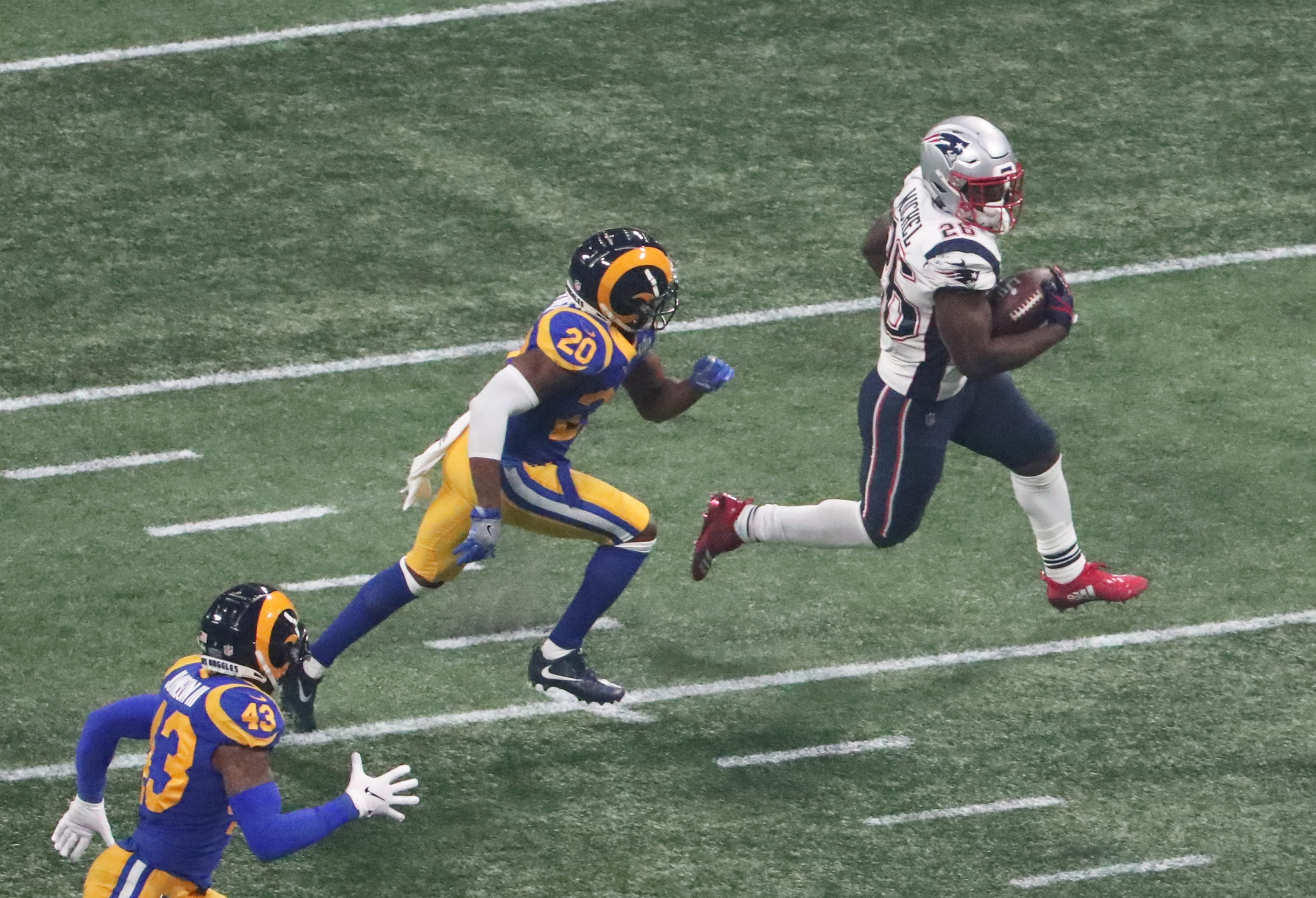 2/3/19 - Atlanta - New England Patriots running back Sony Michel (26) runs the ball for a first down in the fourth quarter against the Los Angeles Rams on Sunday, Feb. 3, 2019 during Super Bowl LIII at Mercedes-Benz Stadium in Atlanta, Ga. (ALYSSA POINTER/ALYSSA.POINTER@AJC.COM)
