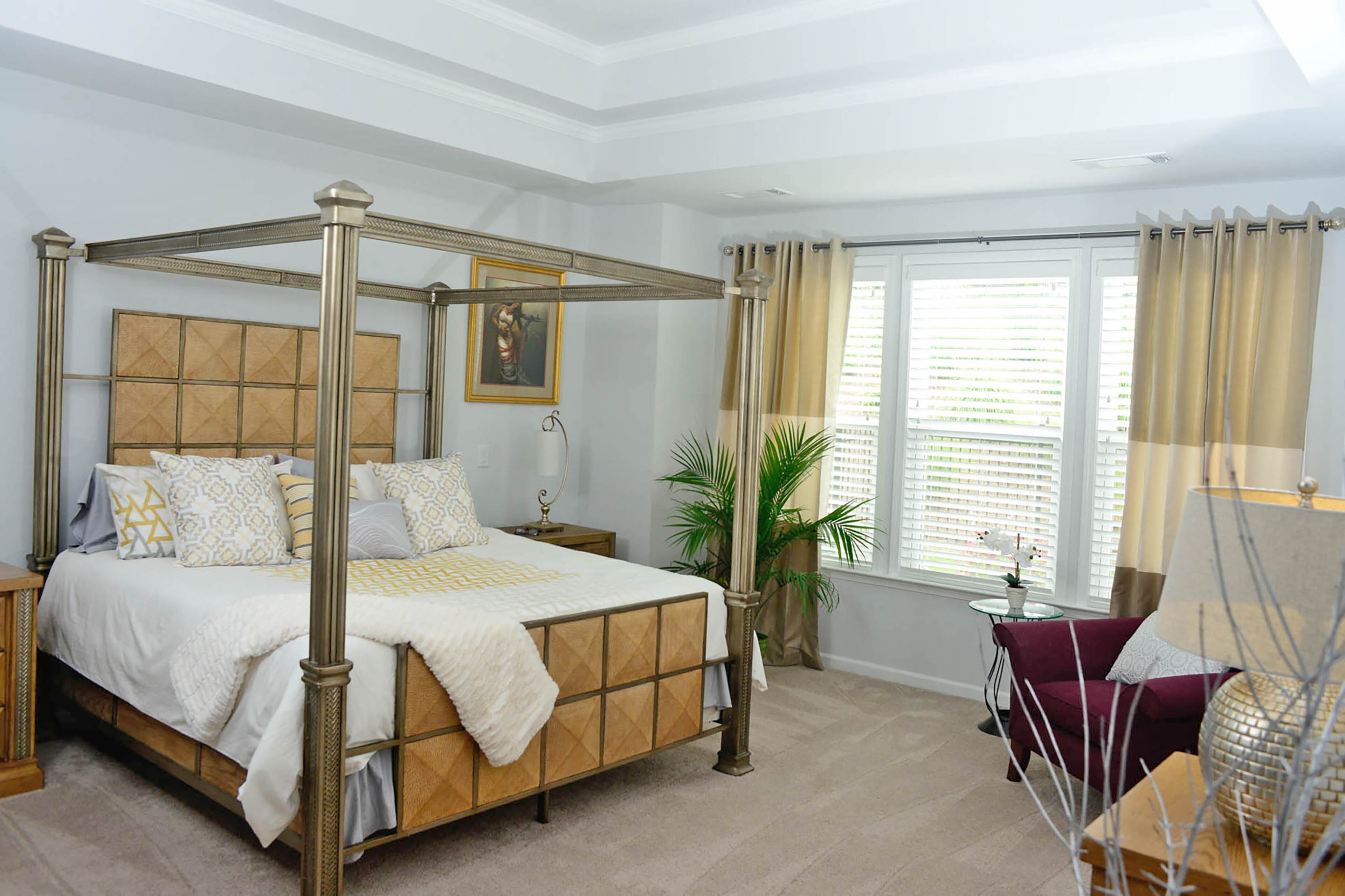 Soft, neutral tones and bedding from West Elm make the master bedroom a calm retreat. When the Wares built the home, they were able to style it with a mix of new items and their own decor, including the bedroom set they purchased years ago from Ashley Furniture.