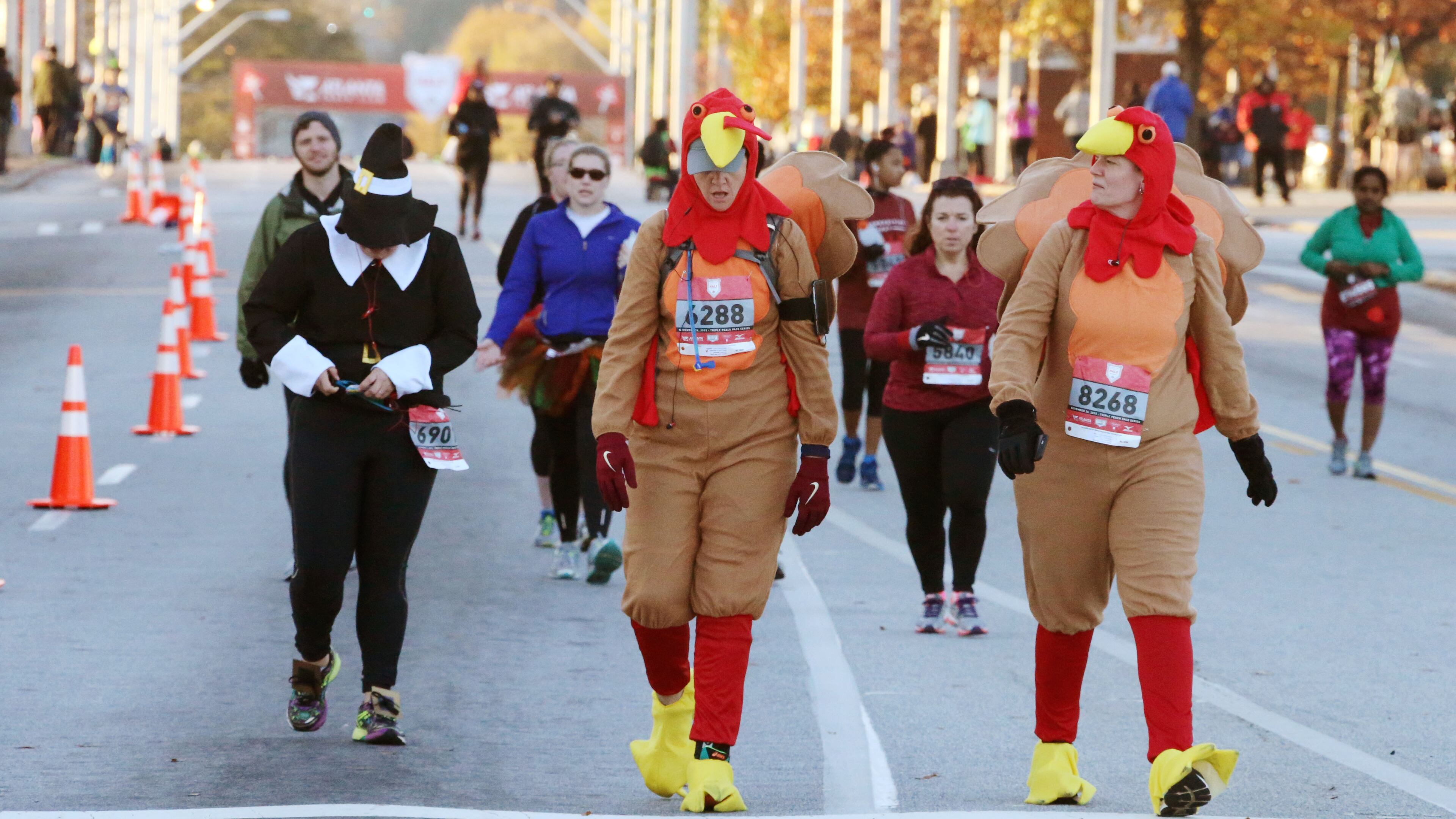 Sara Haskew (left), from Atlanta, and Christina Watts, from Decatur went full turkey Thursday morning to take part in the Thanksgiving Day Half Marathon events in downtown Atlanta. The half marathon, 5K, one mile and 50-meter dash started and finished at Turner Field. Geraint Davis of Suwanee, who was last year's second-place finisher, won the half marathon with a time of 1:10:54. Jill Braley of Rome broke the tape for the women in 1:18:47. She was also the female champion in 2013. BOB ANDRES / BANDRES@AJC.COM