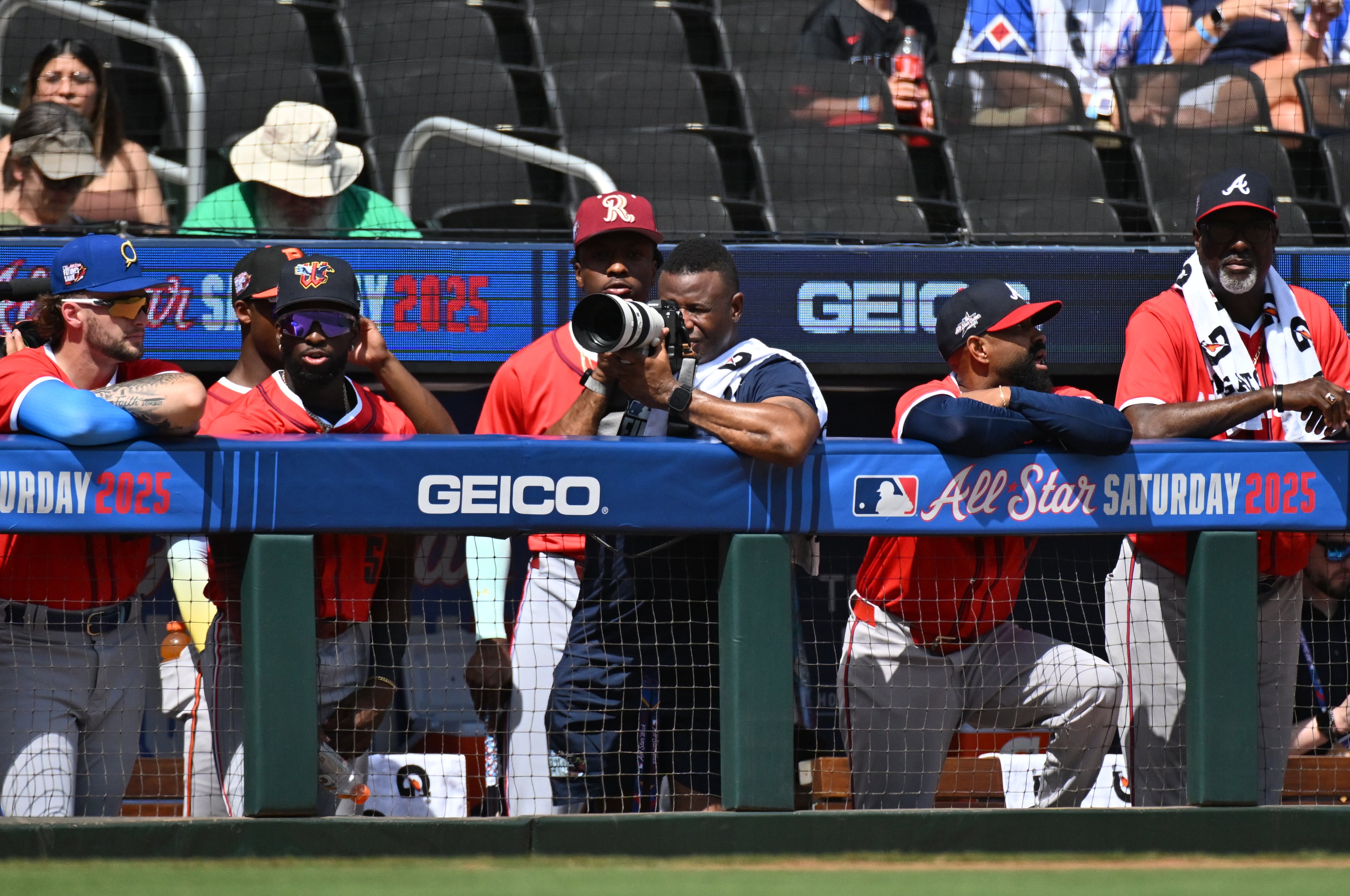 Baseball Hall of Famer Ken Griffey Jr. takes pictures from American League dugout during the first inning of the All-Star Futures Game at Truist Park, Saturday, July 12, 2025, in Atlanta. National League won 4-2 over American League. (Hyosub Shin / AJC)