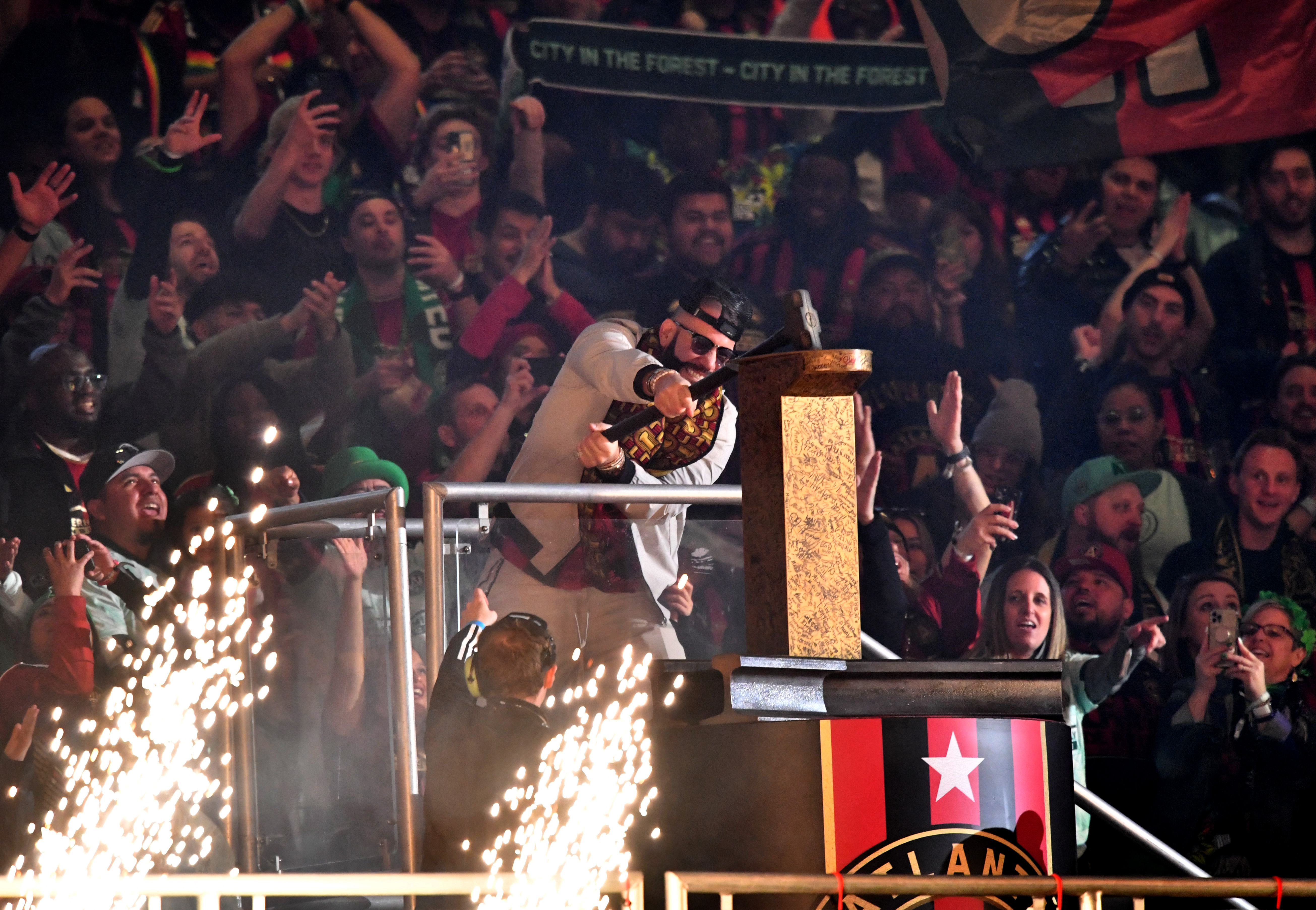 Tyree Simmons, professionally known as DJ Drama, hammers the gold spike to start the game against Portland Timbers in a MLS soccer match at Mercedes-Benz Stadium, Saturday, March 18, 2023, in Atlanta. Atlanta United won 5-1 over Portland Timbers. (Hyosub Shin / Hyosub.Shin@ajc.com)