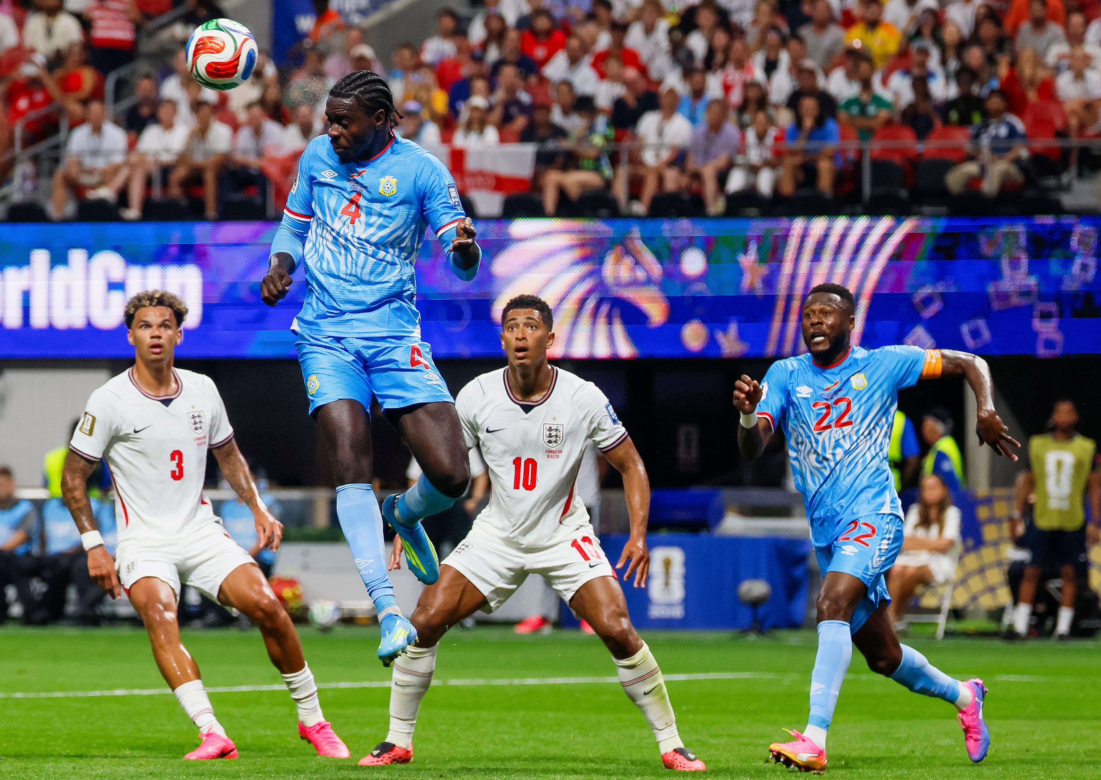 Congo defender Axel Tuanzebe (second from left) heads the ball past England defender Nico O'Reilly (left) and midfielder Jude Bellingham (second from right) during the first half of a FIFA World Cup round of 32 match at Atlanta Stadium (Mercedes-Benz Stadium) on Wednesday, July 1, 2026, in Atlanta. (Miguel Martinez/AJC)
