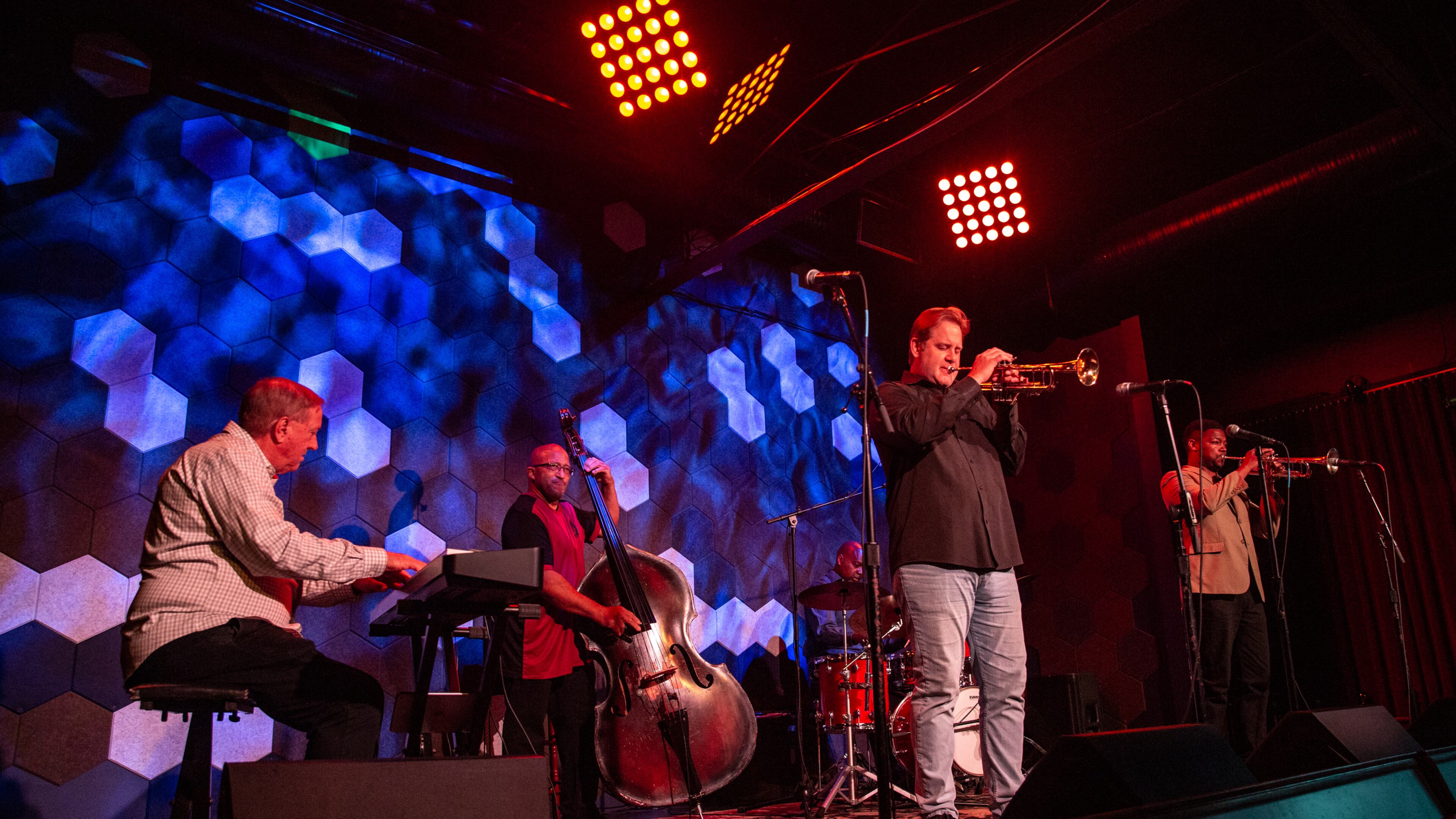 Venkman's in the Fourth Ward is home to Joe Gransden's Jazz Jam every Wednesday where many of Atlanta's jazz greats gather to watch and perform. The July 13 jam starts off with Geoffrey Haydon on keyboard, from left, Craig Shaw on upright bass, Gransden on trumpet with Terence Harper on trumpet. (Jenni Girtman for The Atlanta Journal-Constitution)