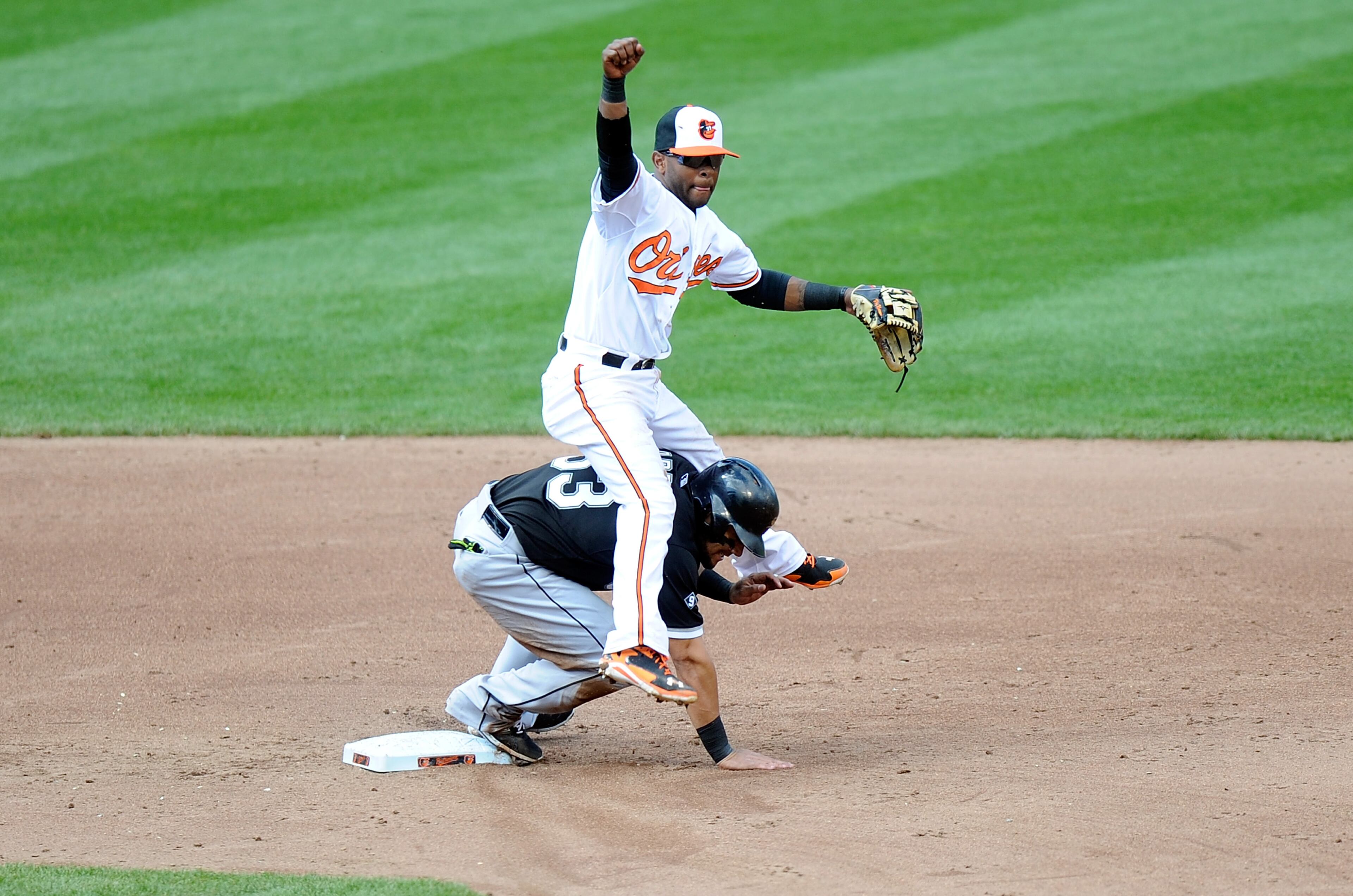 BALTIMORE, MD - APRIL 29: Reynaldo Navarro #43 of the Baltimore Orioles lands on Melky Cabrera #53 of the Chicago White Sox after completing a double play in the sixth inning at Oriole Park at Camden Yards on April 29, 2015 in Baltimore, Maryland. The game was played without spectators due to the social unrest in Baltimore. (Photo by Greg Fiume/Getty Images)