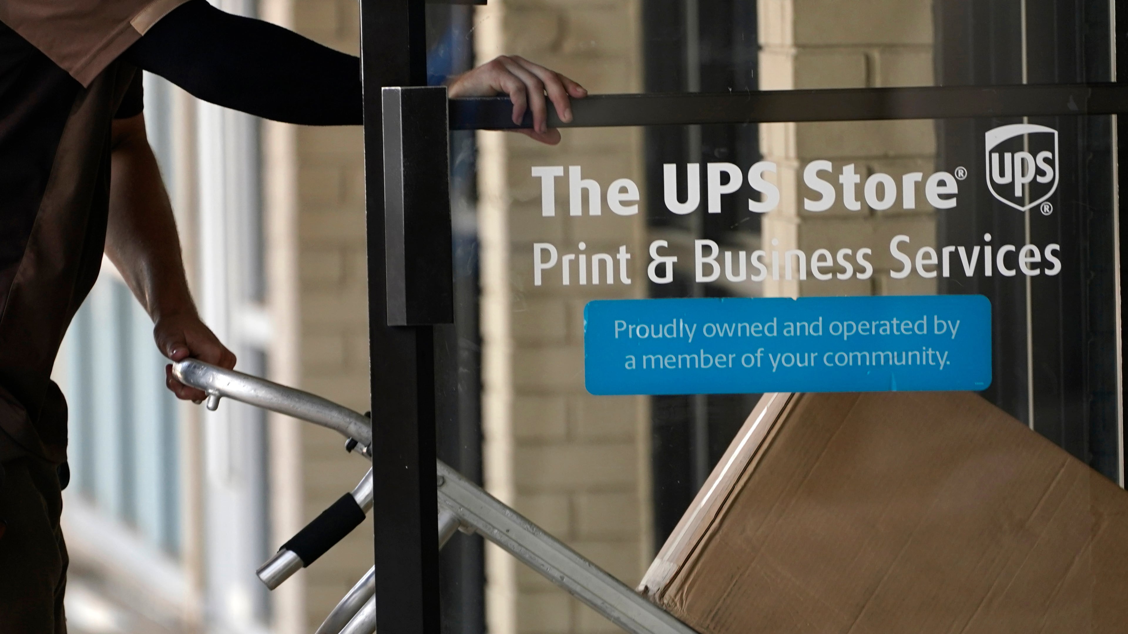 FILE - A UPS driver enters a United Parcel Service store with packages in Jackson, Miss., July 26, 2021. (AP Photo/Rogelio V. Solis, File)