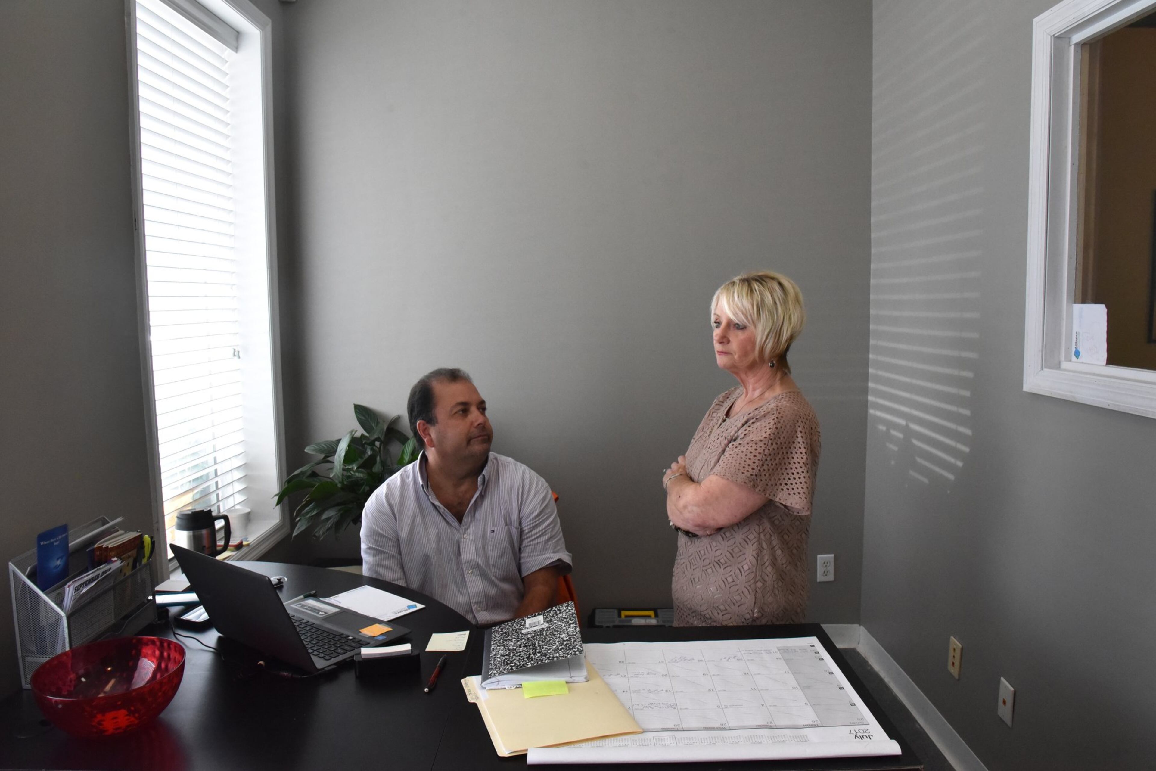 July 28, 2017 Ringgold - Catoosa County coroner Vanita Hullander pauses as she talks to Johnny Long while she is visiting her daughter’s office in Ringgold on Friday, July 28, 2017. A new law gives Georgia a little more power to address potential problems of methadone clinics. HYOSUB SHIN / HSHIN@AJC.COM