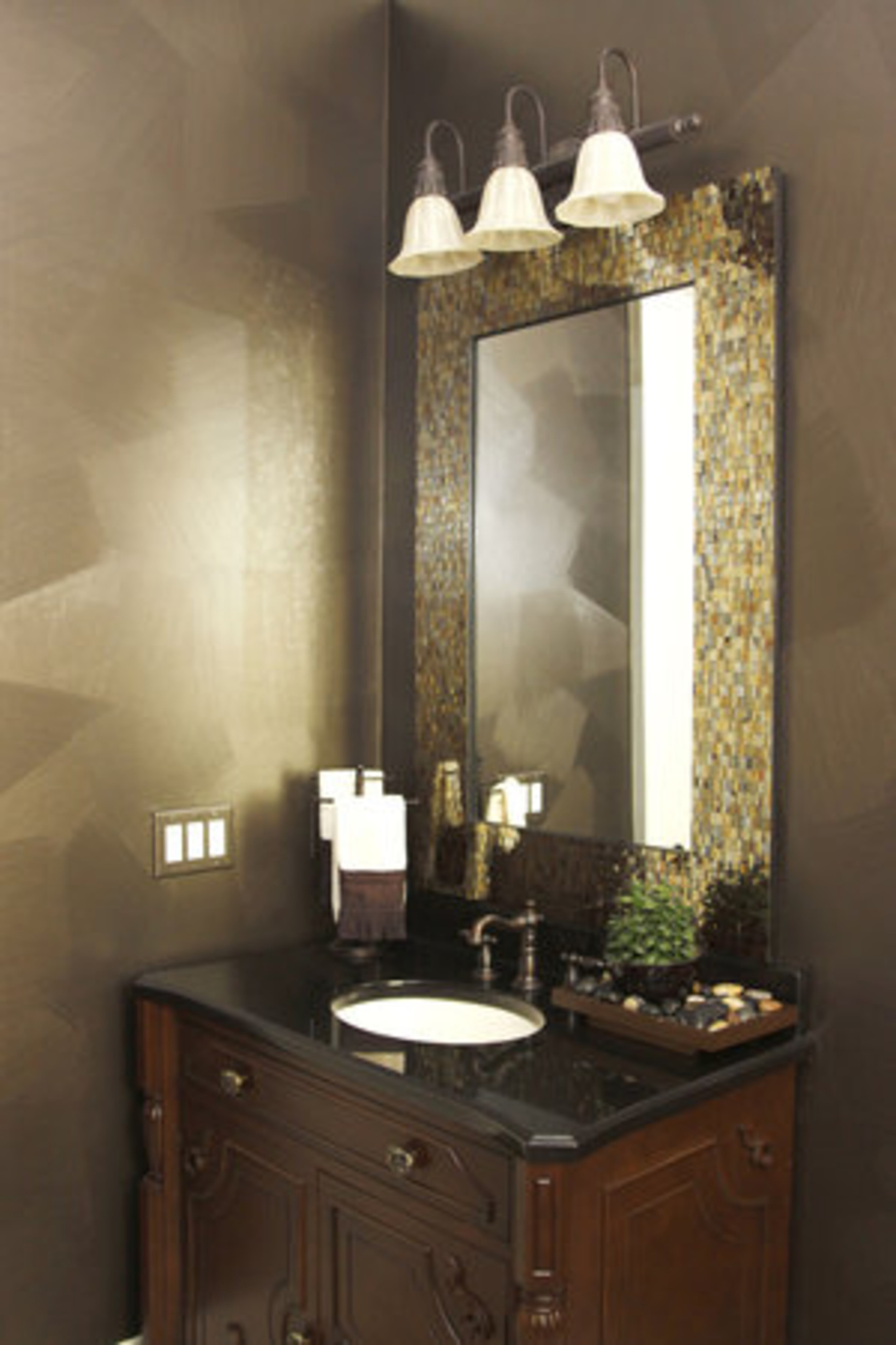 The guest bath features a moody and shimmery brushed metal faux finish by Tobey Sanders of FauxDecor.