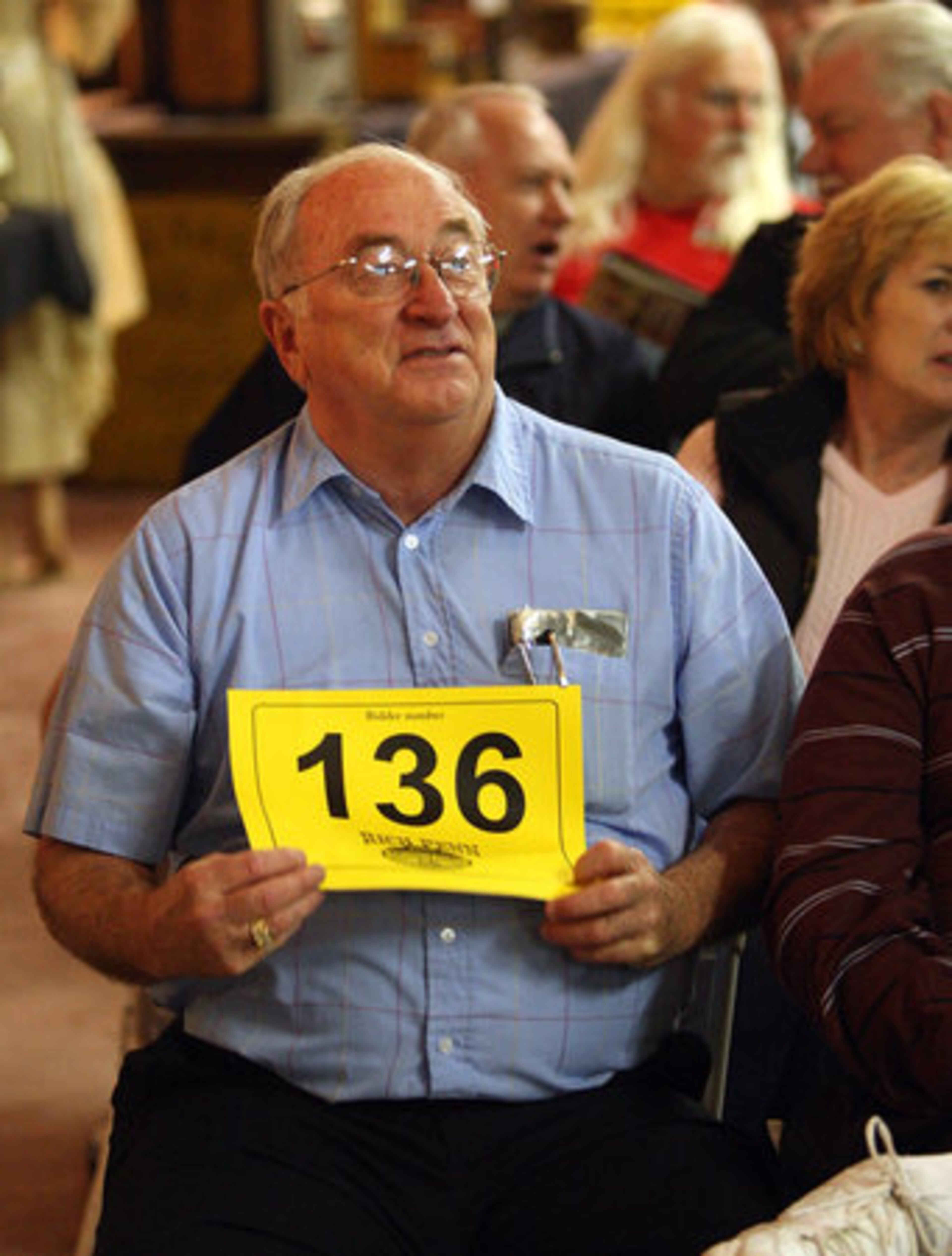 James McDonald, from McDonough, is the high bidder for some Coca-Cola collectibles.