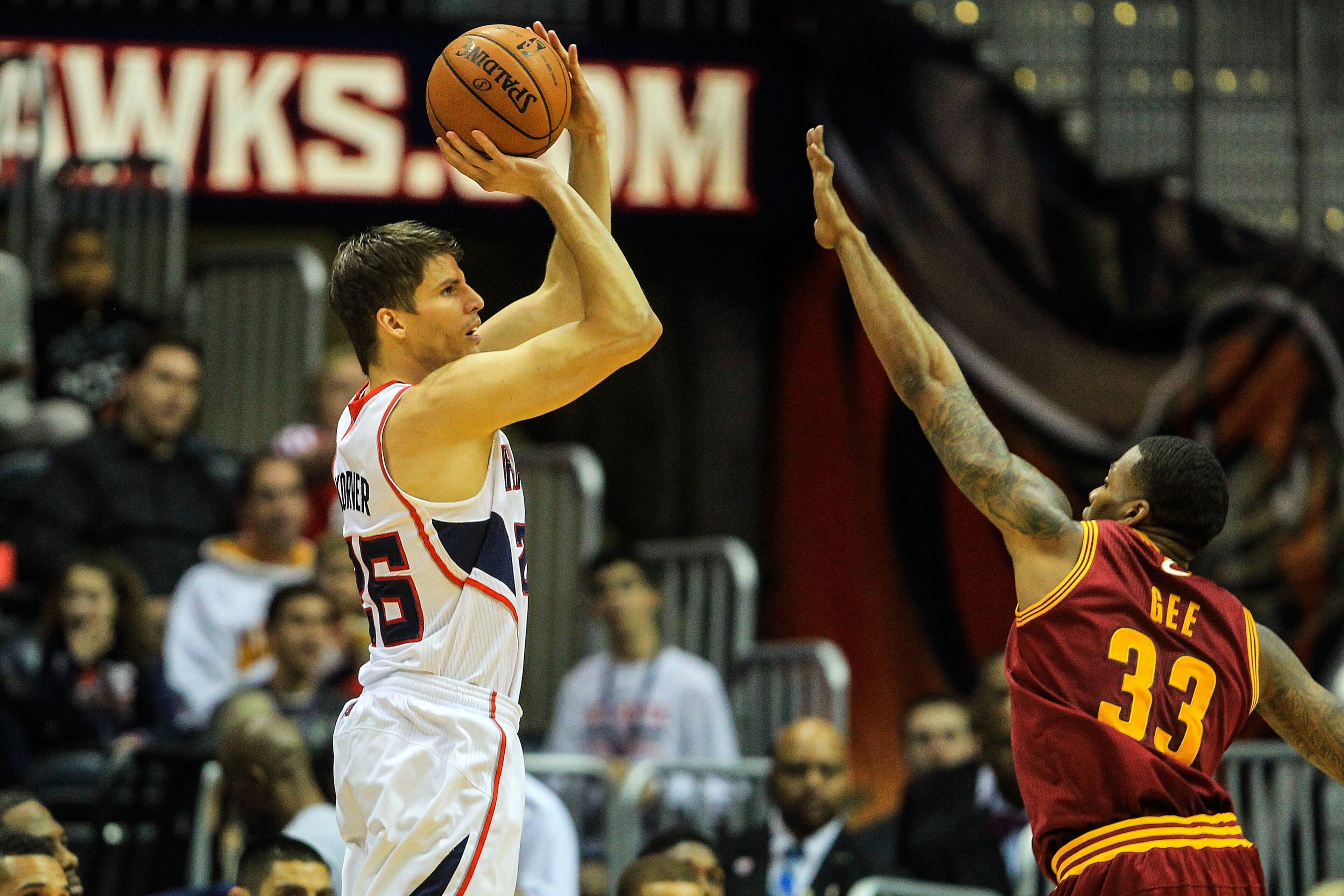 Atlanta Hawks shooting guard Kyle Korver (26) attempts a three over Cleveland Cavaliers small forward Alonzo Gee (33) in the first quarter at Philips Arena.