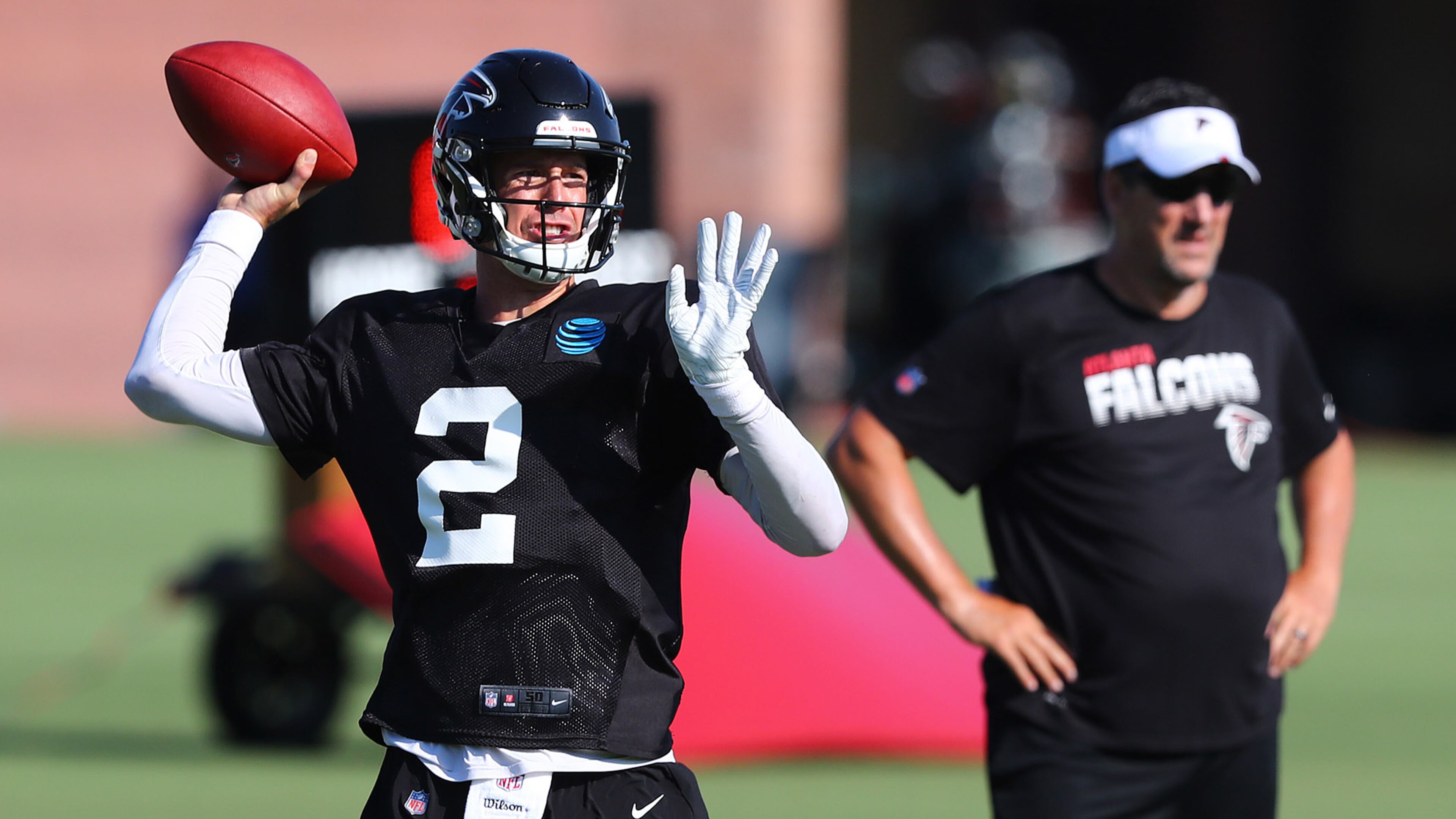 Falcons quarterbacks coach Greg Knapp works with Matt Ryan during training camp Thursday, July 25, 2019, in Flowery Branch.