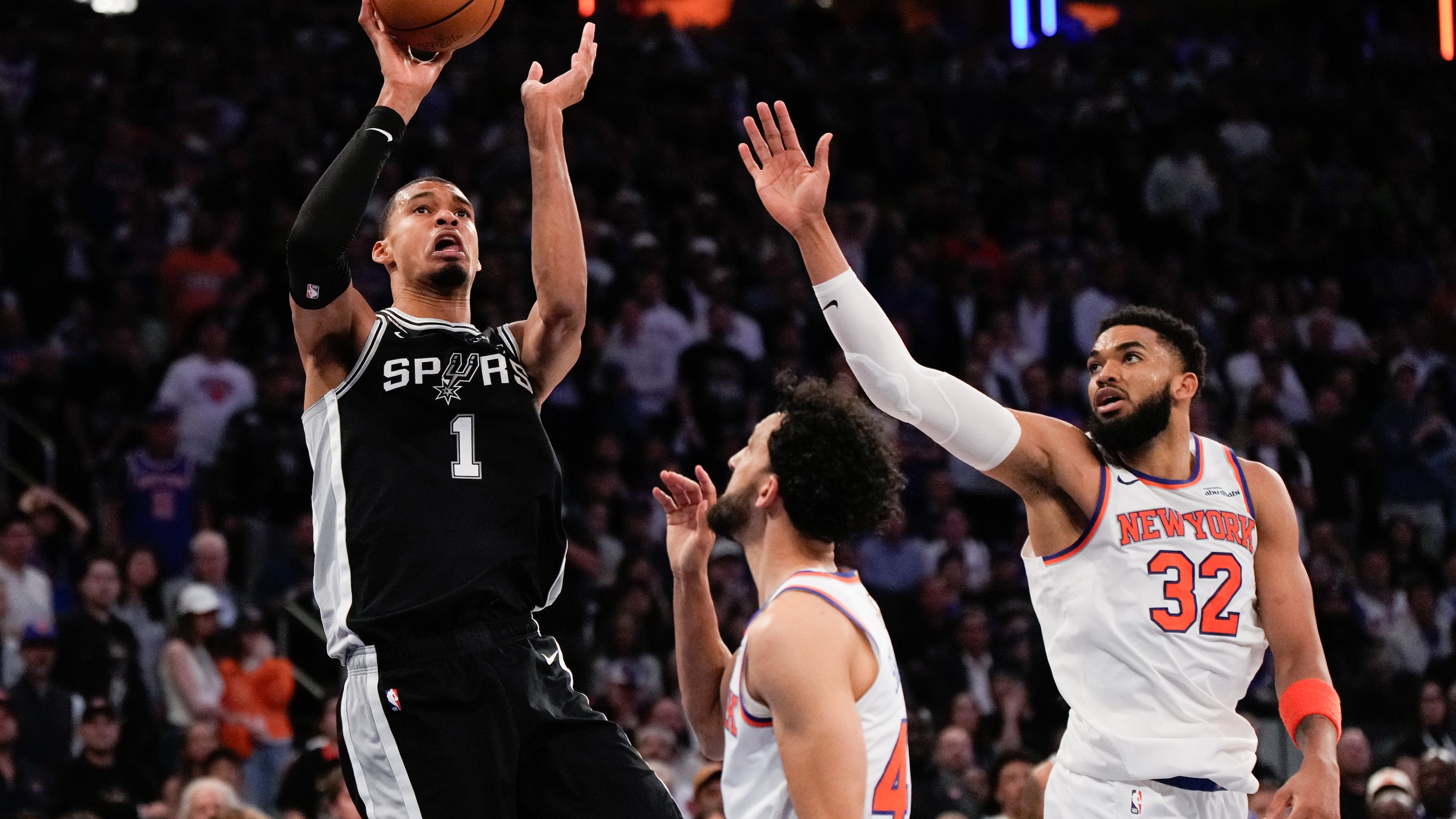 San Antonio Spurs forward Victor Wembanyama (1) shoots over New York Knicks center Karl-Anthony Towns (32) during second half of Game 3 of the NBA Finals basketball series, Monday, June 8, 2026, in New York. (AP Photo/Ross D. Franklin)