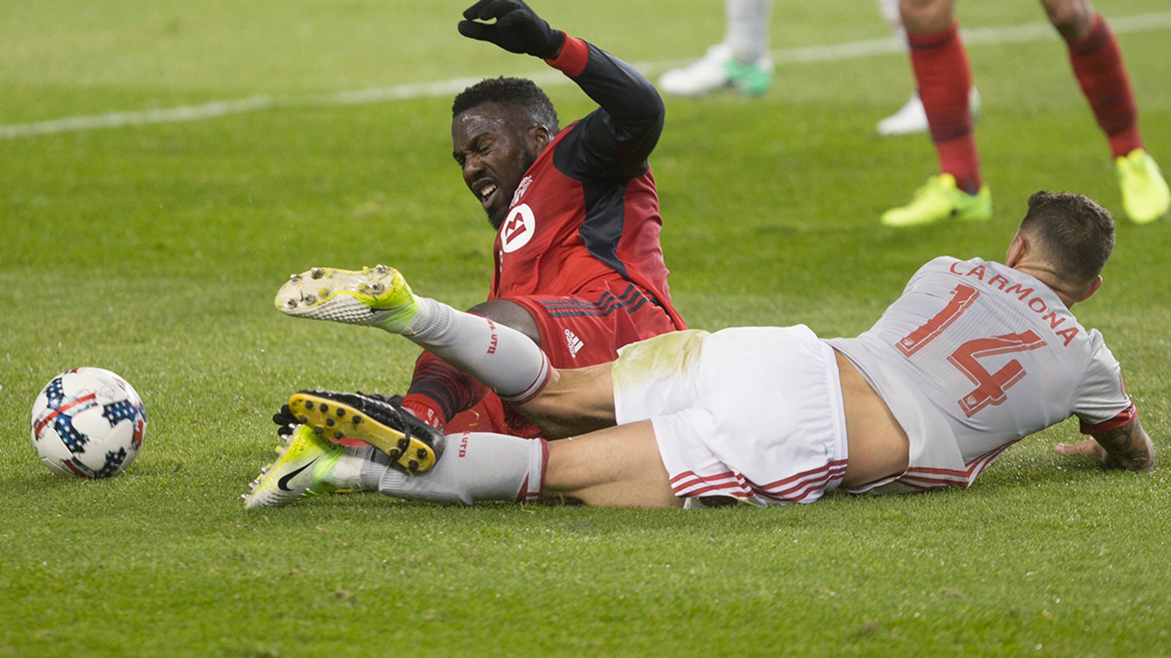 Toronto FC forward Jozy Altidore is brought down by Atlanta United midfielder Carlos Carmona (14) during the first half of an MLS soccer match Saturday, April 8, 2017, in Toronto. (Chris Young/The Canadian Press via AP)