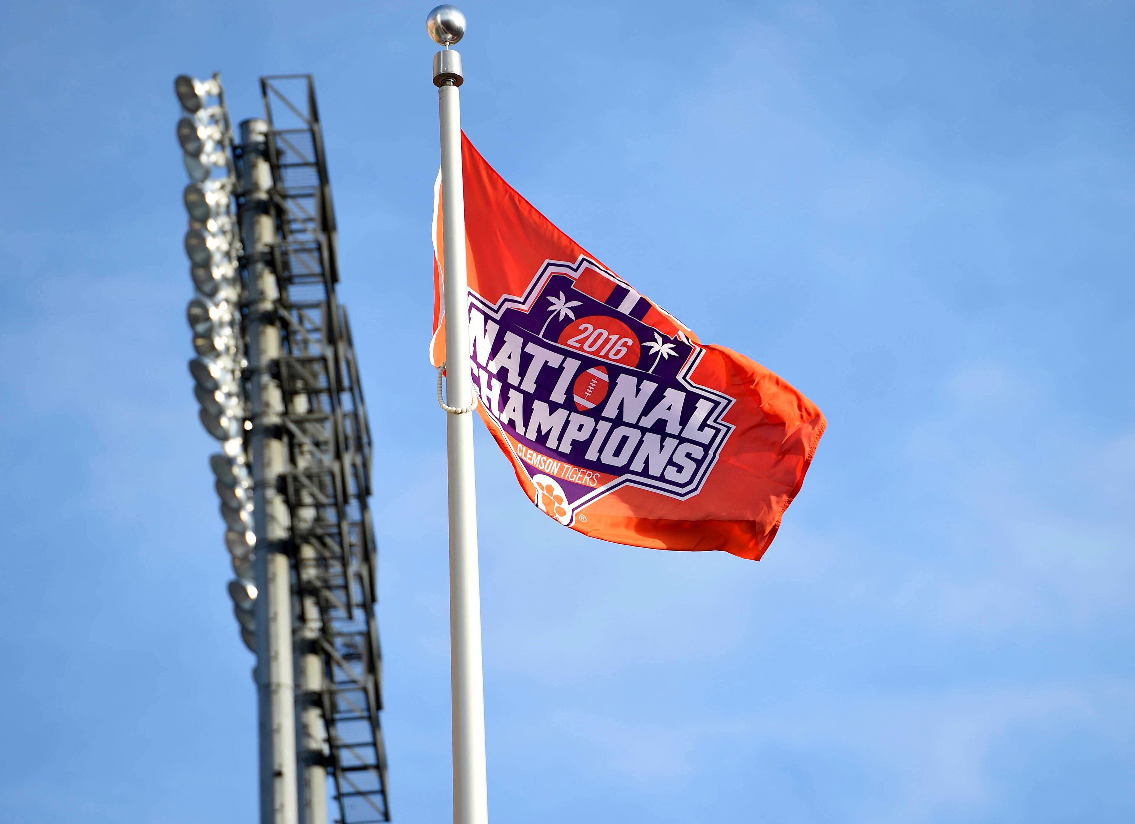 A championship flag flutters at Doug Kingsmore Stadium as the Clemson Tigers returned Tuesday, Jan. 10, 2017, to Clemson, S.C., the day after Clemson defeated Alabama 35-31 in the NCAA College Football Playoff championship game in Tampa, Fla. (AP Photo/Richard Shiro)