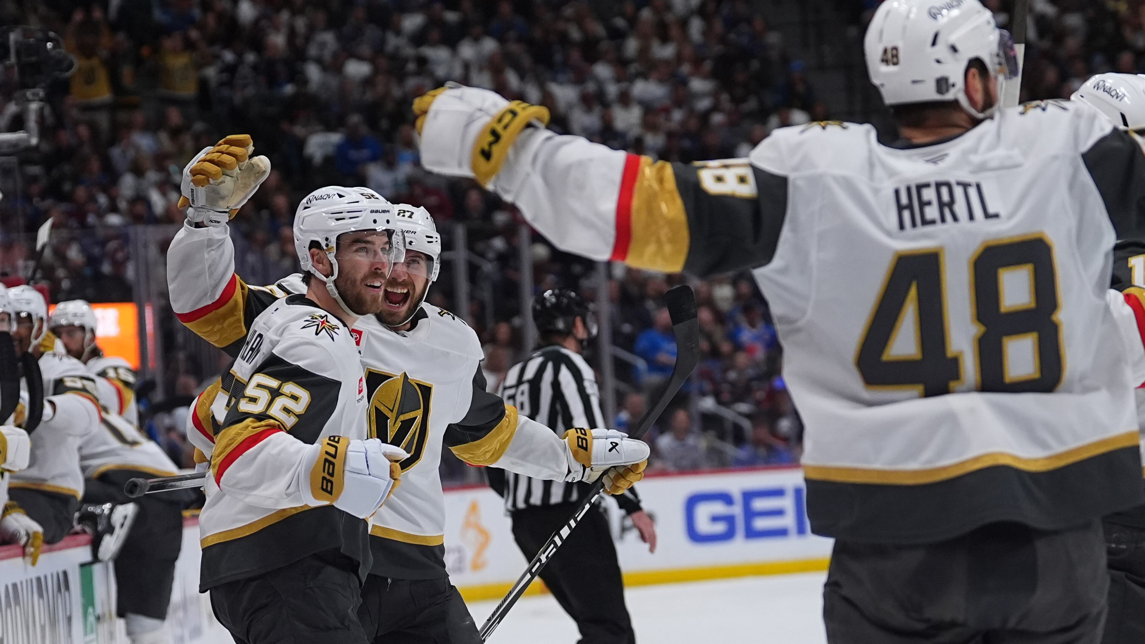 Vegas Golden Knights defenseman Dylan Coghlan, front left, is congratulated after scoring a goal by defenseman Shea Theodore, back left, and center Tomas Hertl during the second period in Game 1 of the Western Conference finals NHL hockey Stanley Cup playoff series against the Colorado Avalanche Wednesday, May 20, 2026, in Denver. (AP Photo/David Zalubowski)