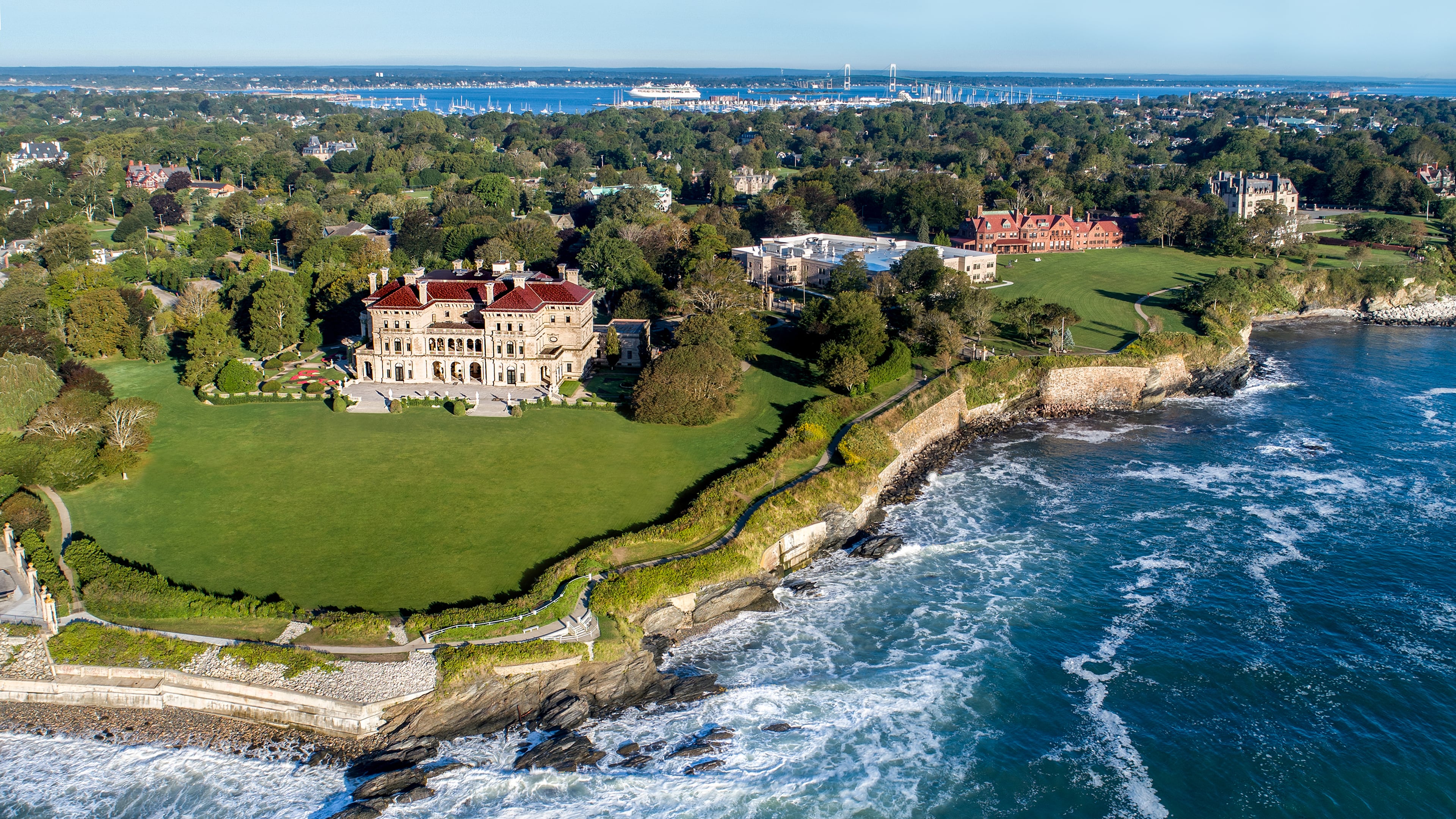 A stretch of Newport’s scenic Cliff Walk passes alongside The Breakers, the Vanderbilt family’s grand Gilded Age mansion in Newport, Rhode Island. (Courtesy of Discover Newport)