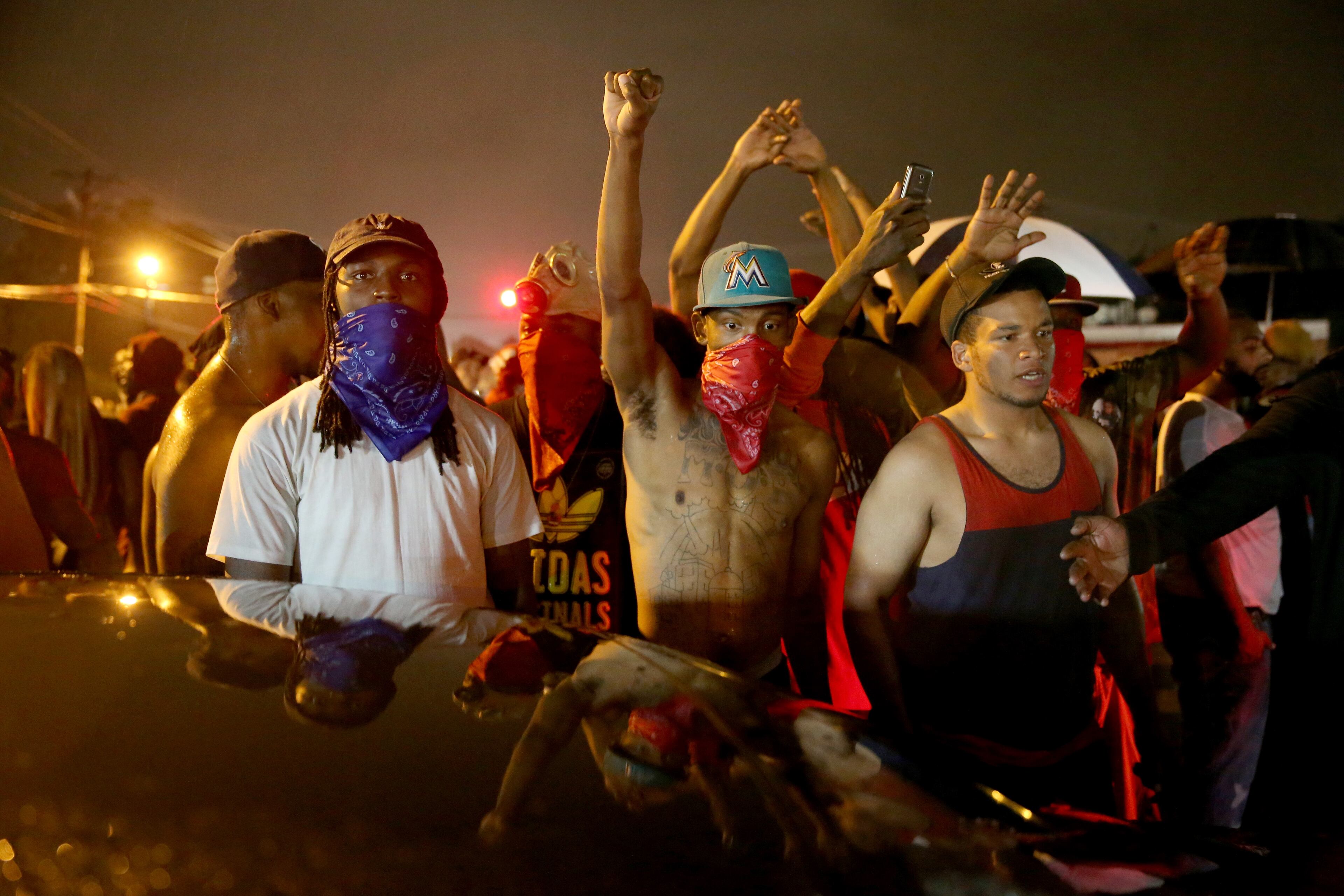 FERGUSON, MO - AUGUST 16: Demonstrators protesting the shooting death of Michael Brown gather together in the street on August 16, 2014 in Ferguson, Missouri. Violent outbreaks have taken place in Ferguson since the shooting death of Michael Brown by a Ferguson police officer on August 9th. (Photo by Joe Raedle/Getty Images)