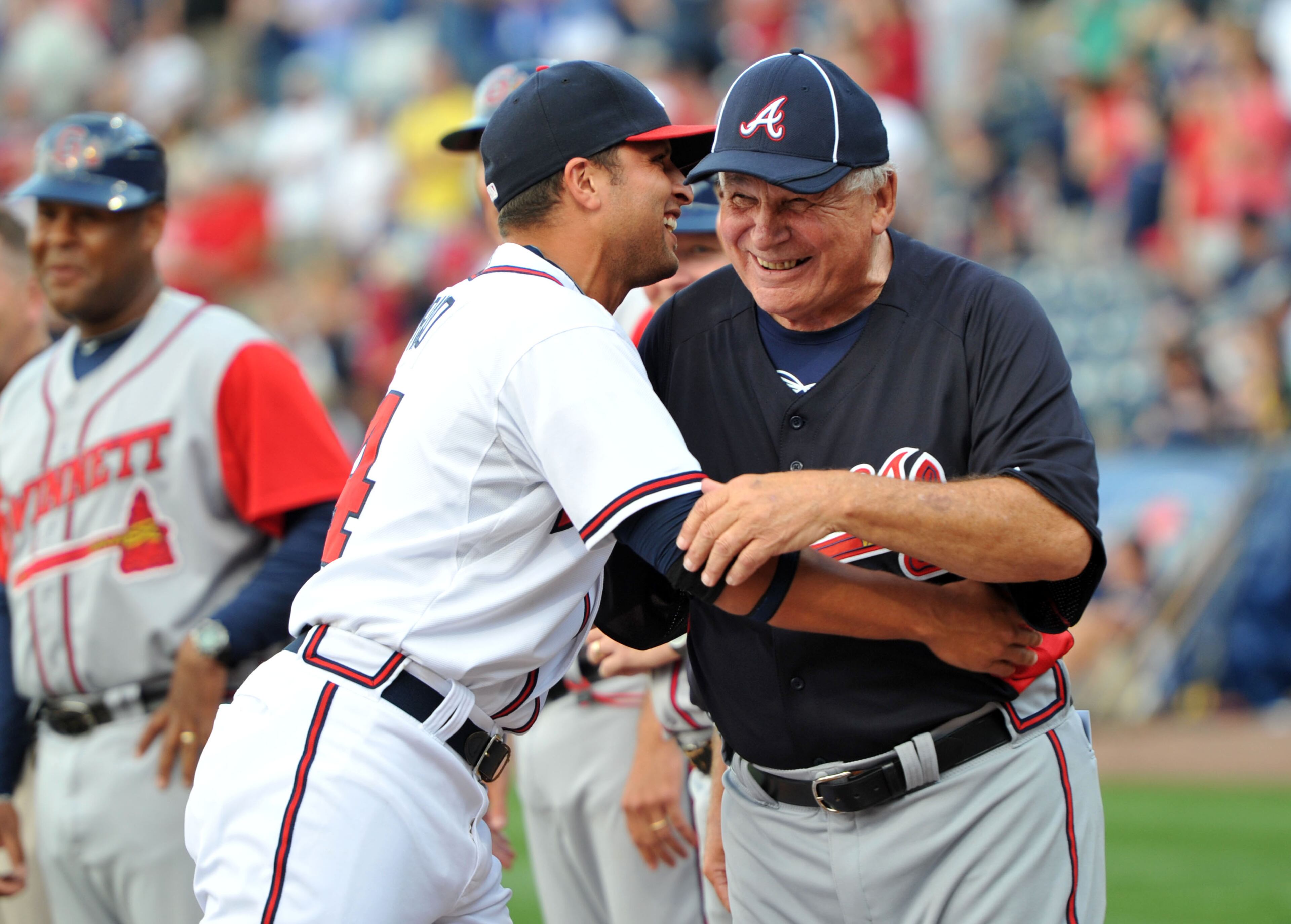 Ex-Atlanta Braves Manager Bobby Cox gets a hug from Atlanta Braves Martin Prado before their exhibition game against the Atlanta Braves Future Starts at Coolray Field in Lawrenceville on Tuesday, April 3, 2012. Hyosub Shin, hshin@ajc.com