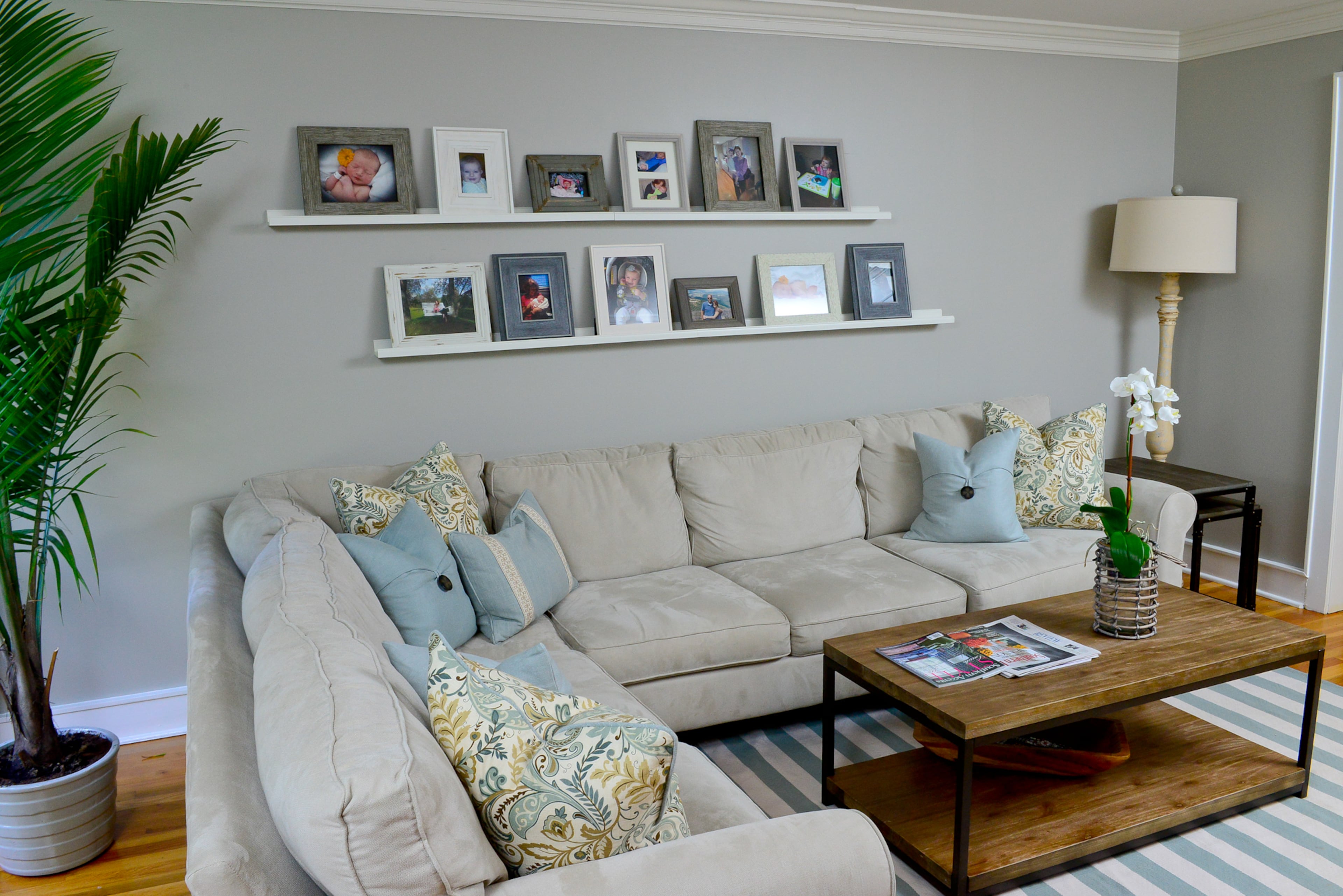 A sectional centers the family room, which has a new coffee table from Home Decorators Collection, custom pillows by Lauren Harris Interiors and floor lamp by Zeugma Import. The rug is from Dash & Albert.