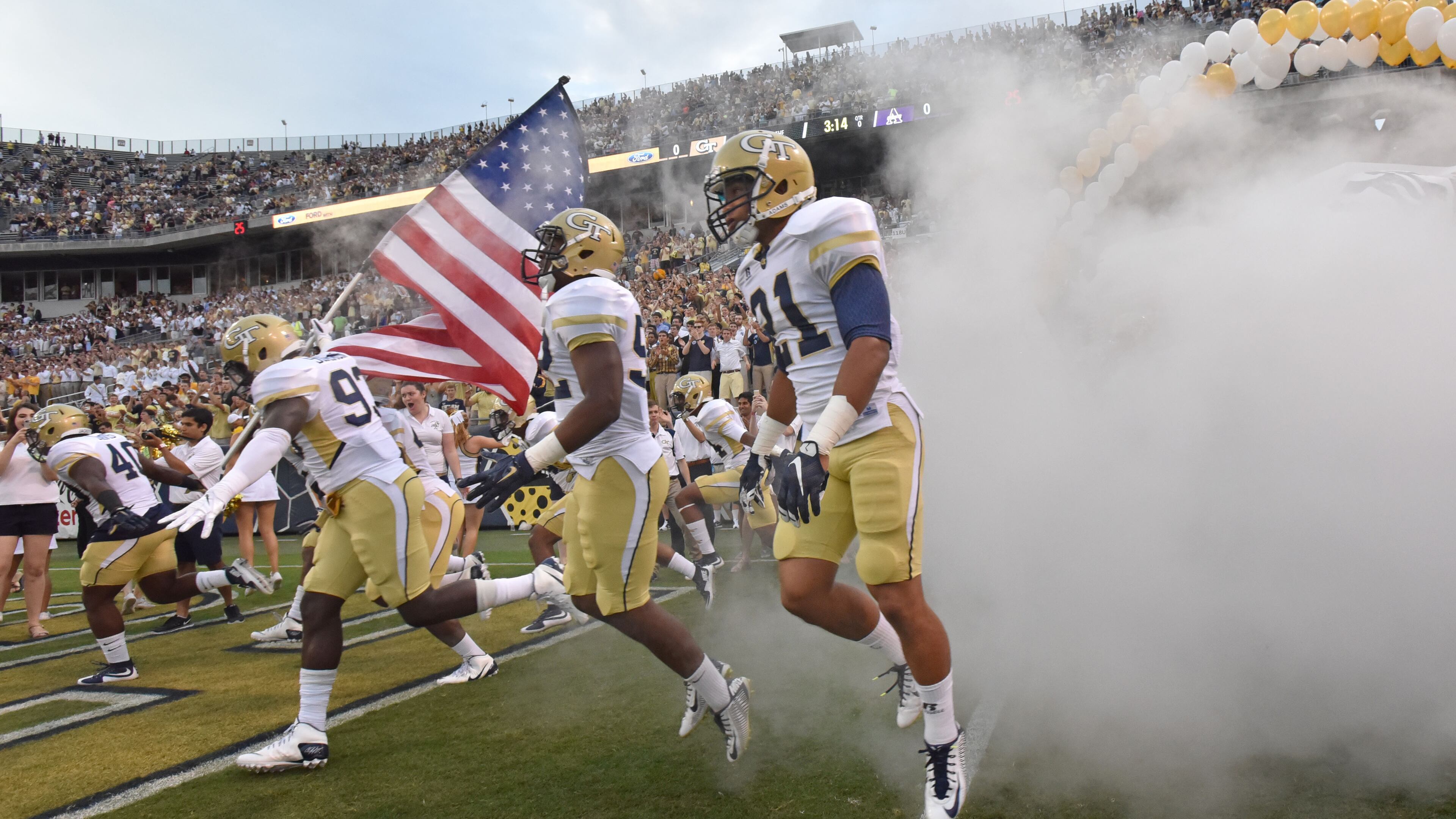 Georgia Tech players run on to the field before the start of the Georgia Tech season opener against the Alcorn State Braves in Bobby Dodd Stadium on Thursday, September 3, 2015. HYOSUB SHIN / HSHIN@AJC.COM