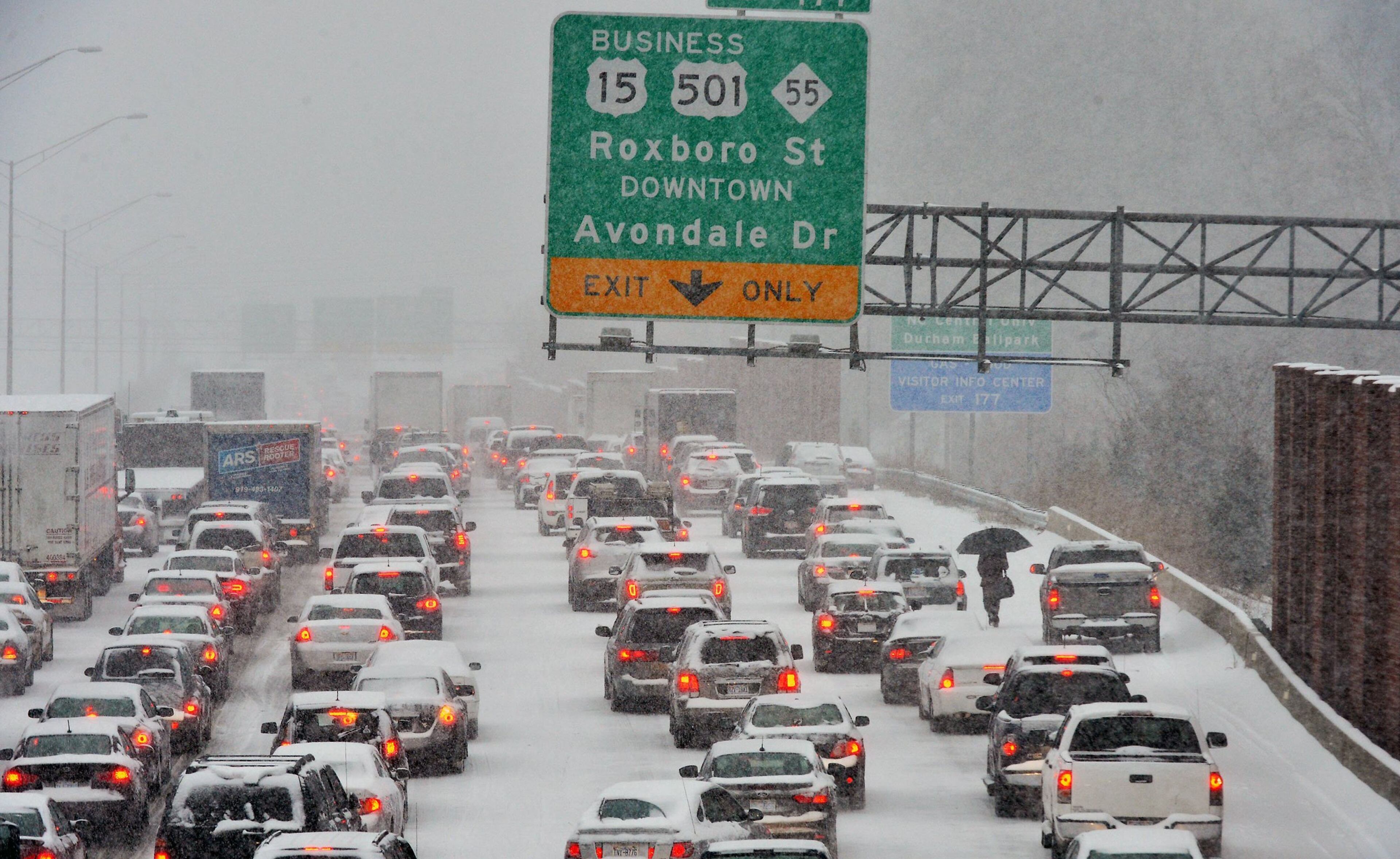 A motorist who abandoned their vehicle walks through traffic stopped on northbound I-85 in Durham, N.C., on Wednesday, Feb. 12, 2014. The Triangle had its biggest storm in several years and most major roads in the area were snarled. (Chuck Liddy/Raleigh News & Observer/MCT)