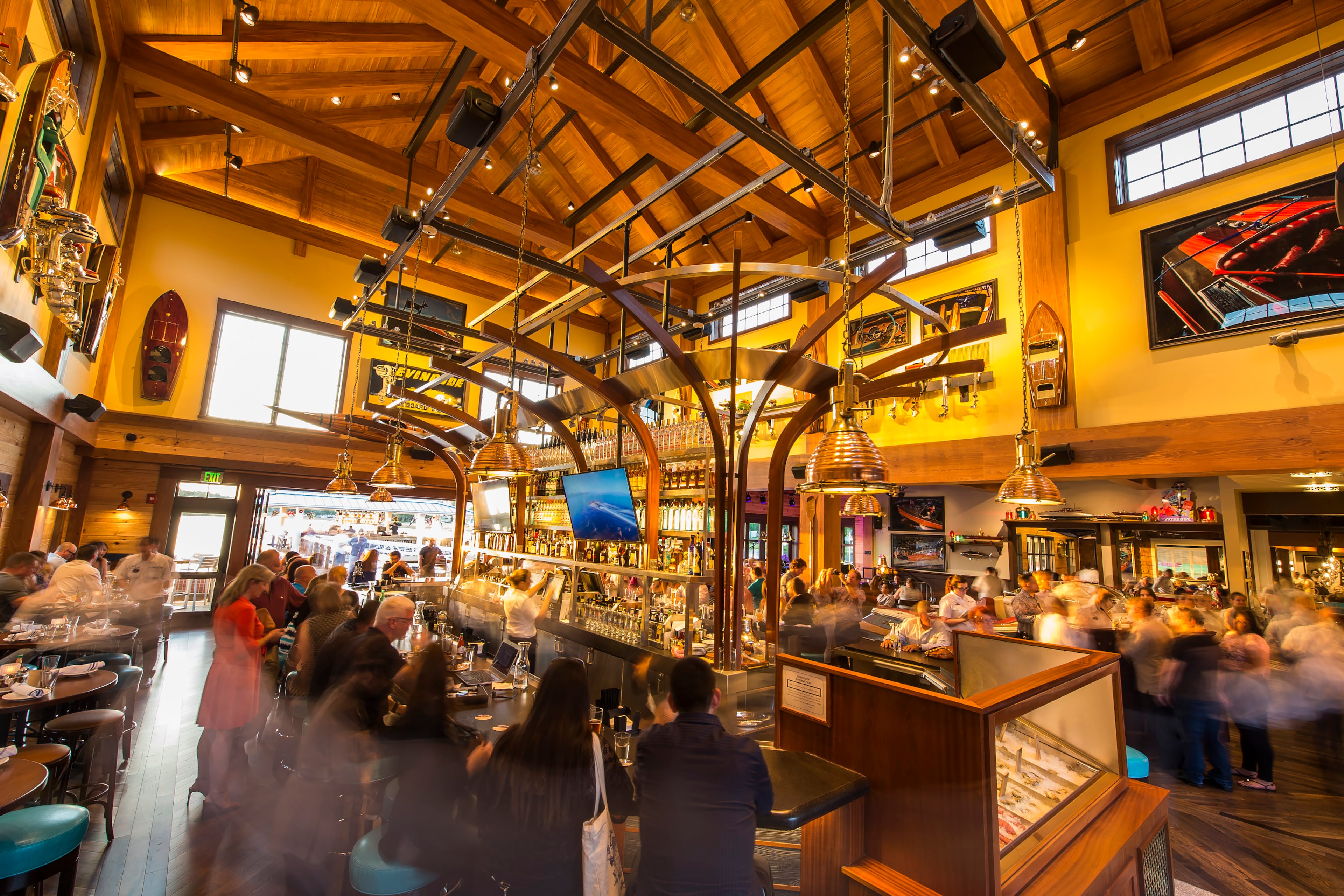 Guests dine at The Captain's Raw Bar inside The BOATHOUSE: Great Food, Waterfront Dining, Dream Boats, an upscale, waterfront dining experience in the heart of Downtown Disney with a gourmet menu featuring steaks, chops and fresh seafood.