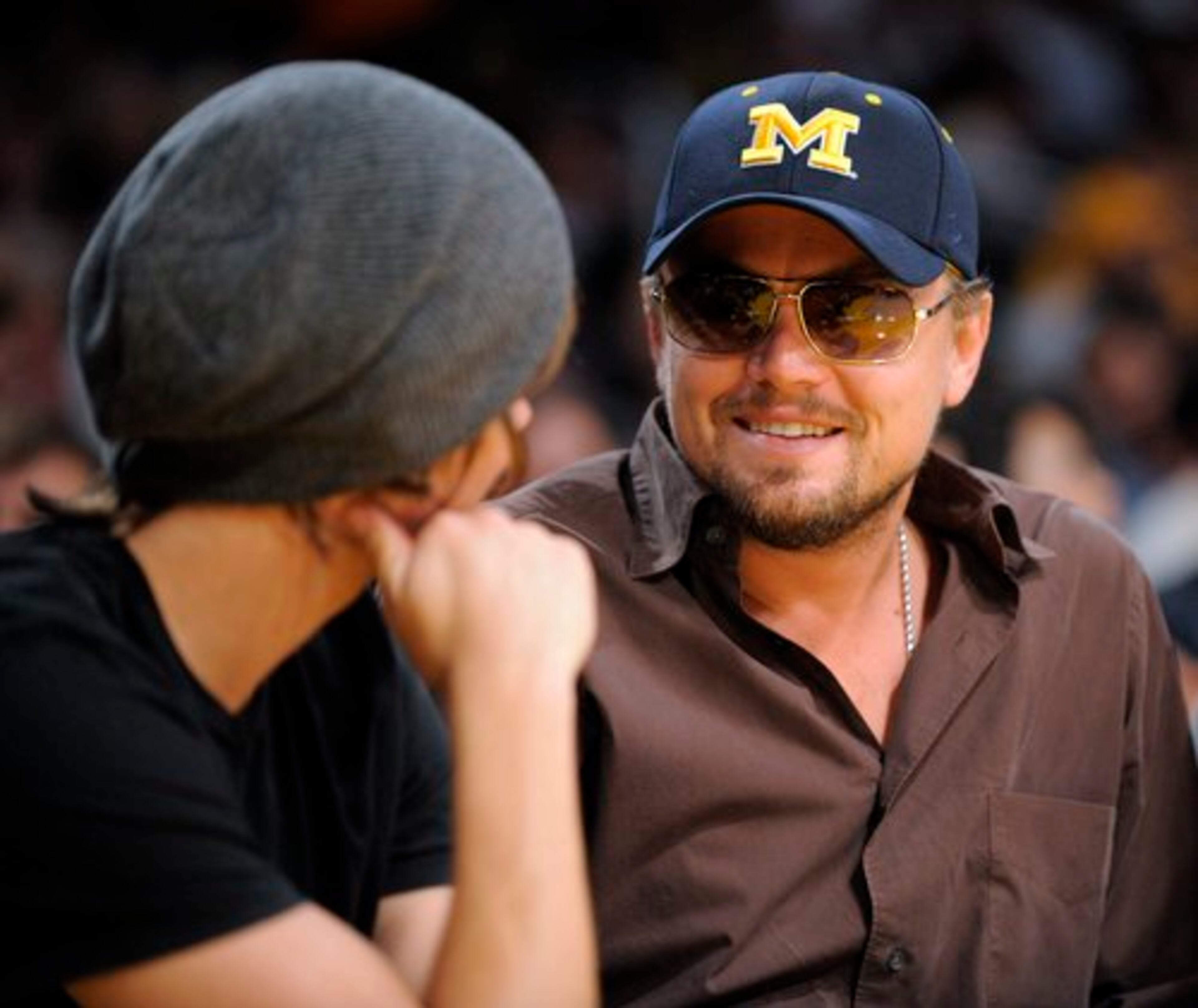 Actor Leonardo DiCaprio, right, seen talking to actor Zac Efron, wore a University of Michigan baseball hat to the game.