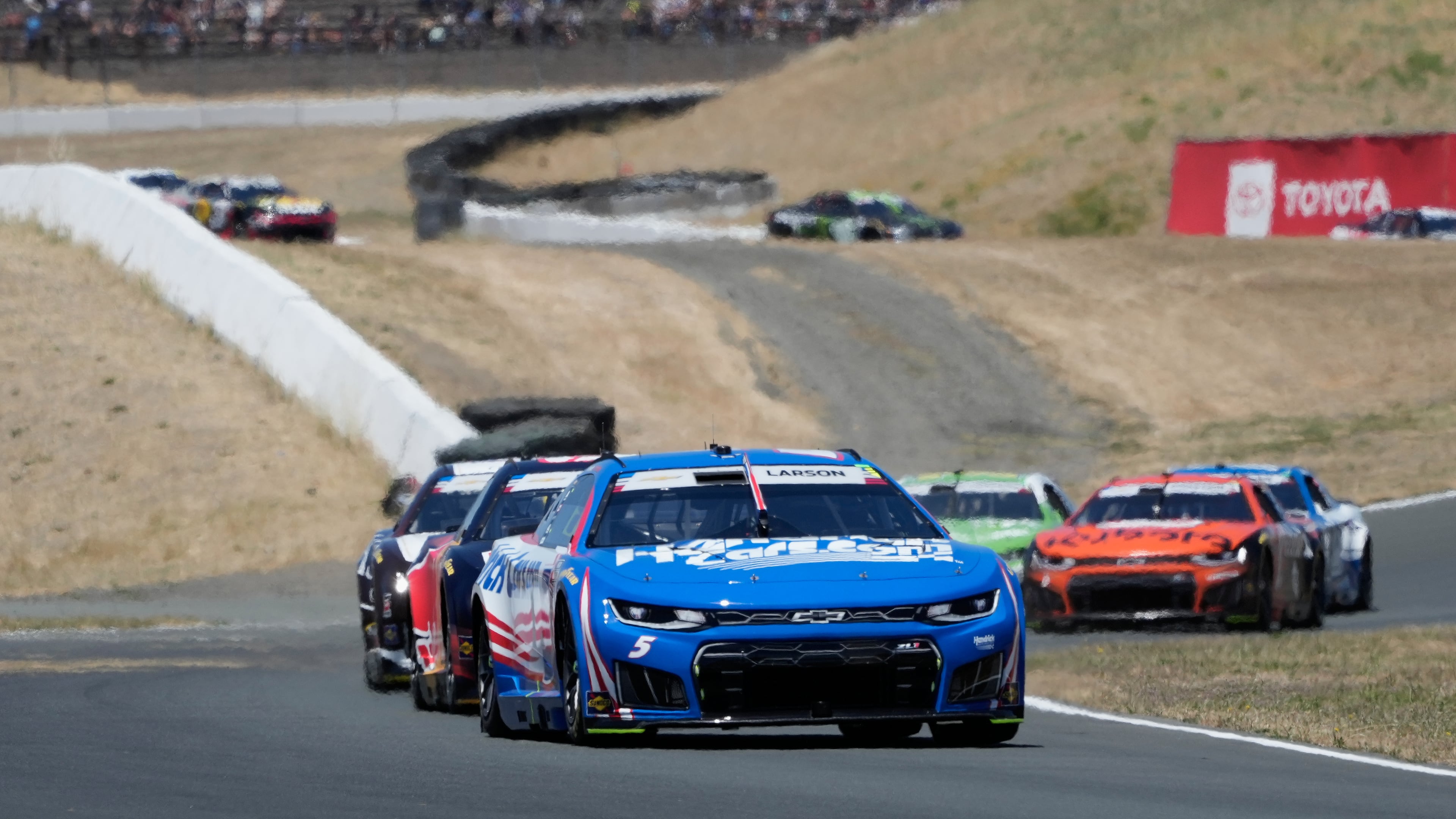 Kyle Larson, foreground, drives in front of cars during a NASCAR Cup Series auto race at Sonoma Raceway, Sunday, June 28, 2026, in Sonoma, Calif. (AP Photo/Jeff Chiu)