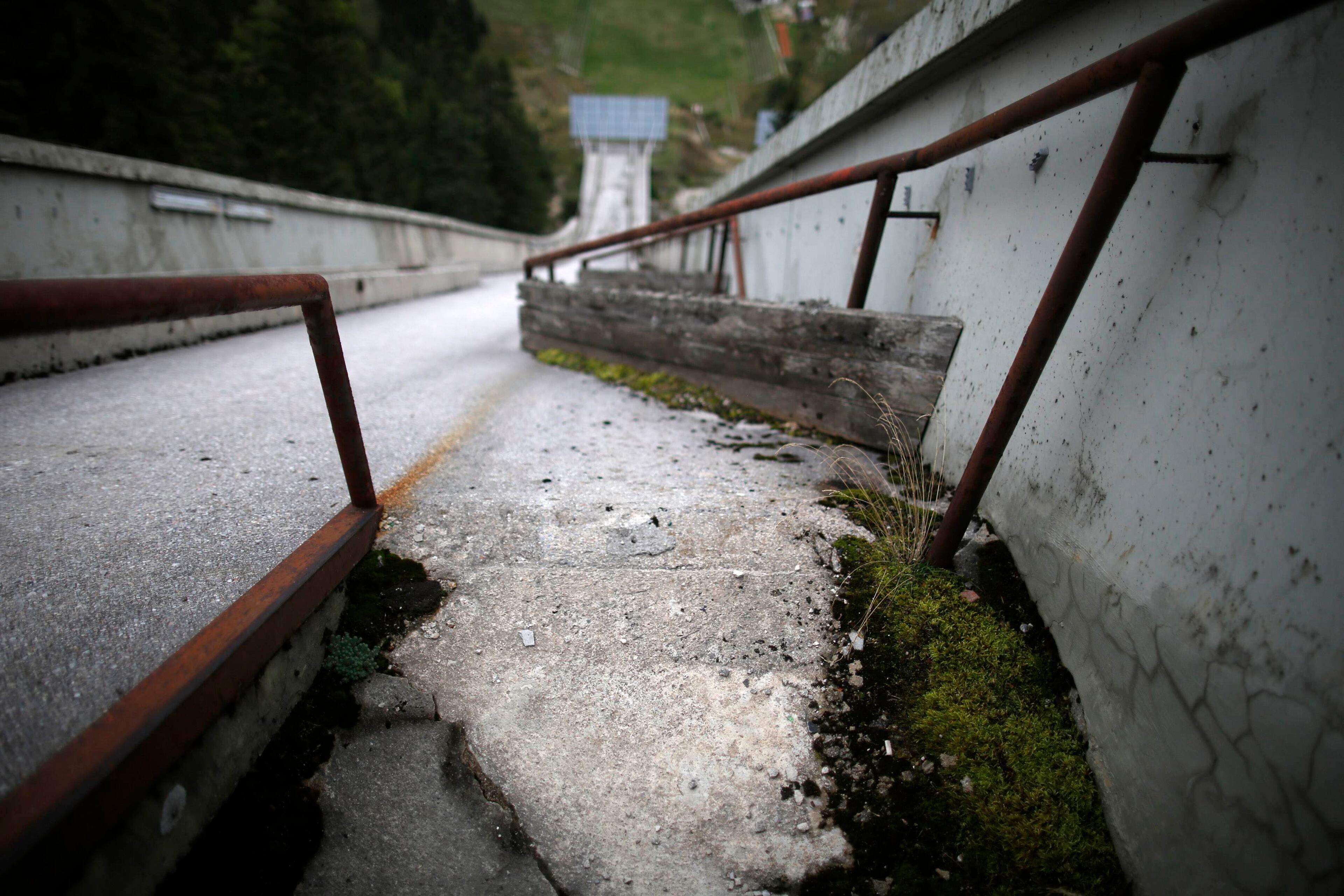 A view of the disused ski jump from the Sarajevo 1984 Winter Olympics on Mount Igman, near Saravejo September 19, 2013. Abandoned and left to crumble into oblivion, most of the 1984 Winter Olympic venues in Bosnia's capital Sarajavo have been reduced to rubble by neglect as much as the 1990s conflict that tore apart the former Yugoslavia. The bobsleigh and luge track at Mount Trebevic, the Mount Igman ski jumping course and accompanying objects are now decomposing into obscurity. The bobsleigh and luge track, which was also used for World Cup competitions after the Olympics, became a Bosnian-Serb artillery stronghold during the war and is nowadays a target of frequent vandalism. The clock is now ticking towards the 2014 Winter Olympics, with October 29 marking 100 days to the opening of the Games in the Russian city of Sochi. Picture taken on September 19, 2013. REUTERS/Dado Ruvic