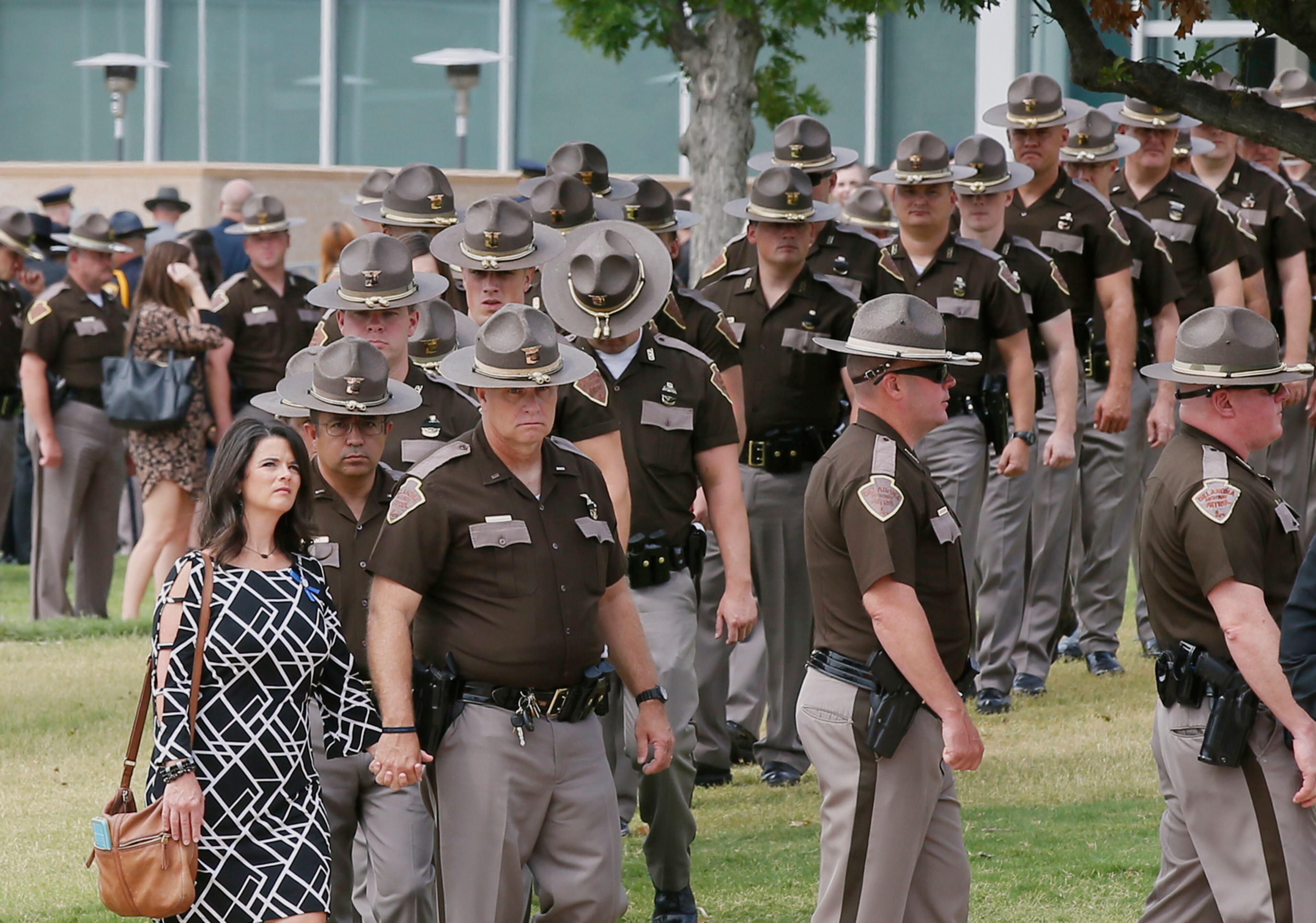 Oklahoma Highway Patrol troopers and their families line up to enter the funeral of Lt. D. Heath Meyer in Norman, Okla., Monday, July 31, 2017. Meyer was struck by another trooper's patrol car during a chase July 14, 2017, and died July 24, 2017. (AP Photo/Sue Ogrocki)