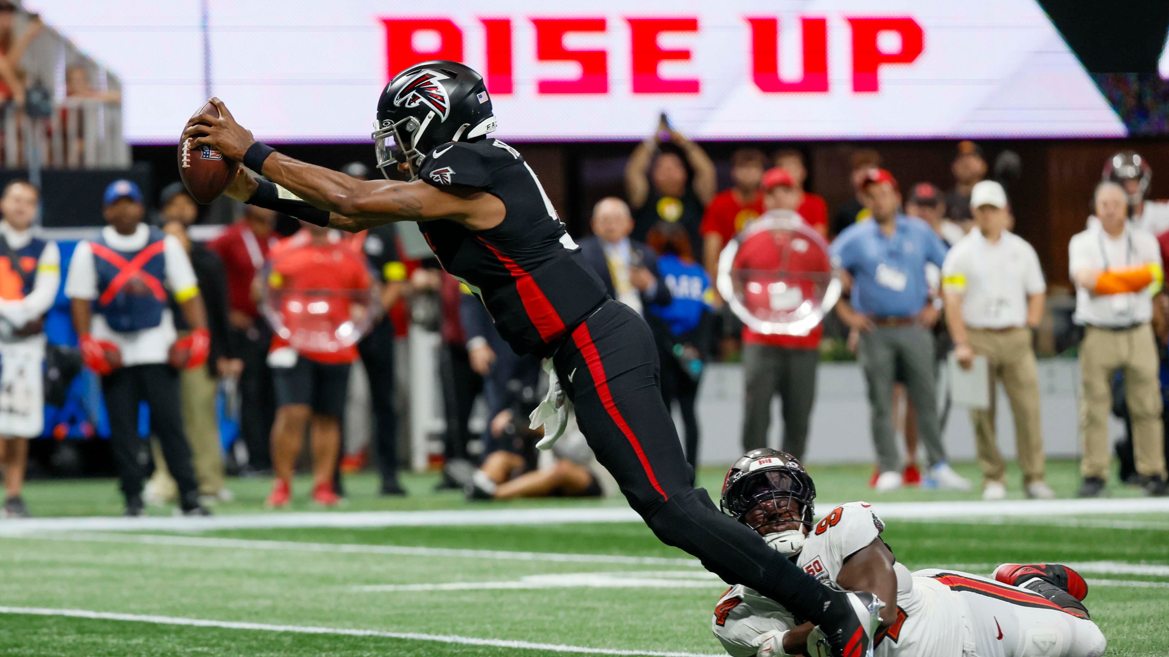 Atlanta Falcons quarterback Michael Penix Jr. dives into the end zone during the second half of Sunday's game against the Tampa Bay Buccaneers. (Miguel Martinez/AJC)