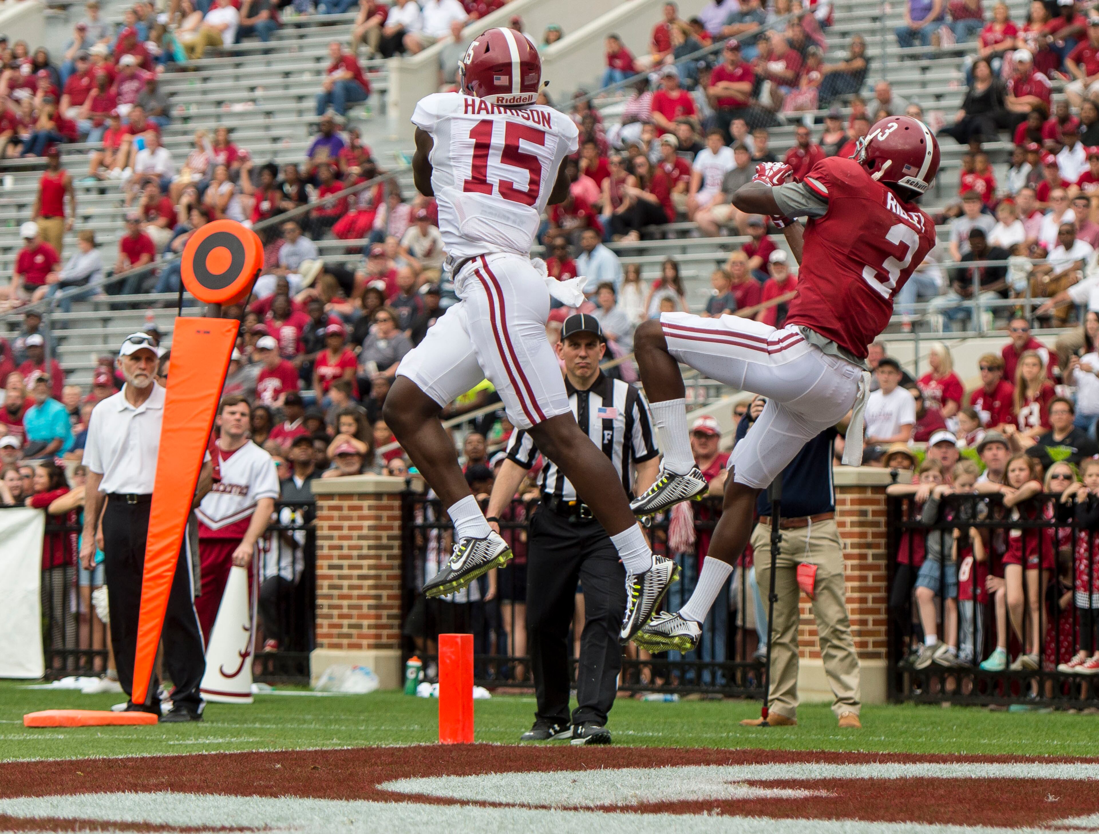 Alabama defensive back Ronnie Harrison (15) makes an interception that kept wide receiver Calvin Ridley (3) from scoring during the second half of the NCAA college football team's A-Day spring game, Saturday, April 16, 2016, in Tuscaloosa, Ala. (Vasha Hunt/AL.com via AP)