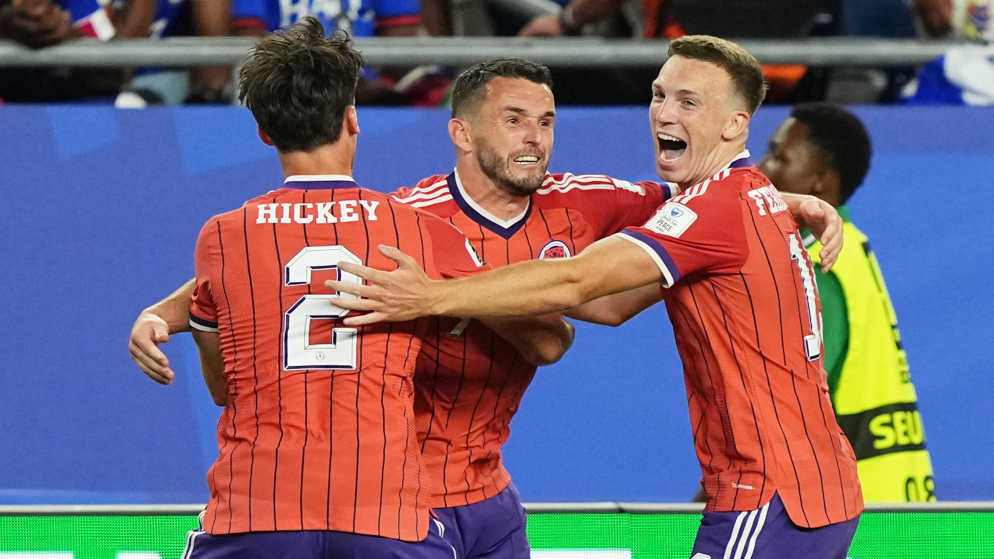Scotland's John McGinn (7) celebrates with teammate's Aaron Hickey (2) and Lewis Ferguson (19) after scoring his teams first goal during the World Cup Group C soccer match between Haiti and Scotland in Foxborough, Mass., near Boston, Saturday, June 13, 2026. (AP Photo/Martin Meissner)