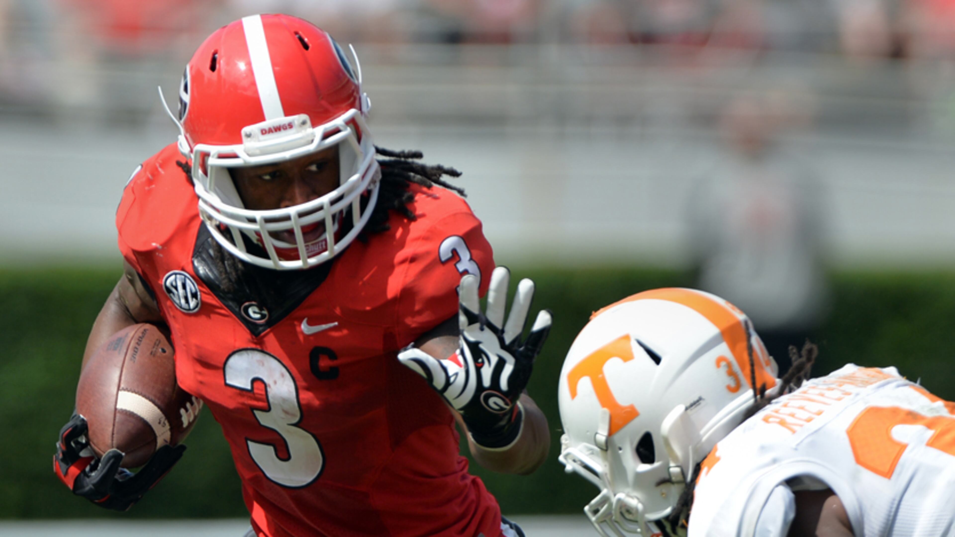 Georgia Bulldogs running back Todd Gurley tries to elude the tackle of Tennessee Volunteers linebacker Jalen Reeves-Maybin during the second quarter at Sanford Stadium Saturday September 27, 2014. BRANT SANDERLIN / BSANDERLIN@AJC.COM