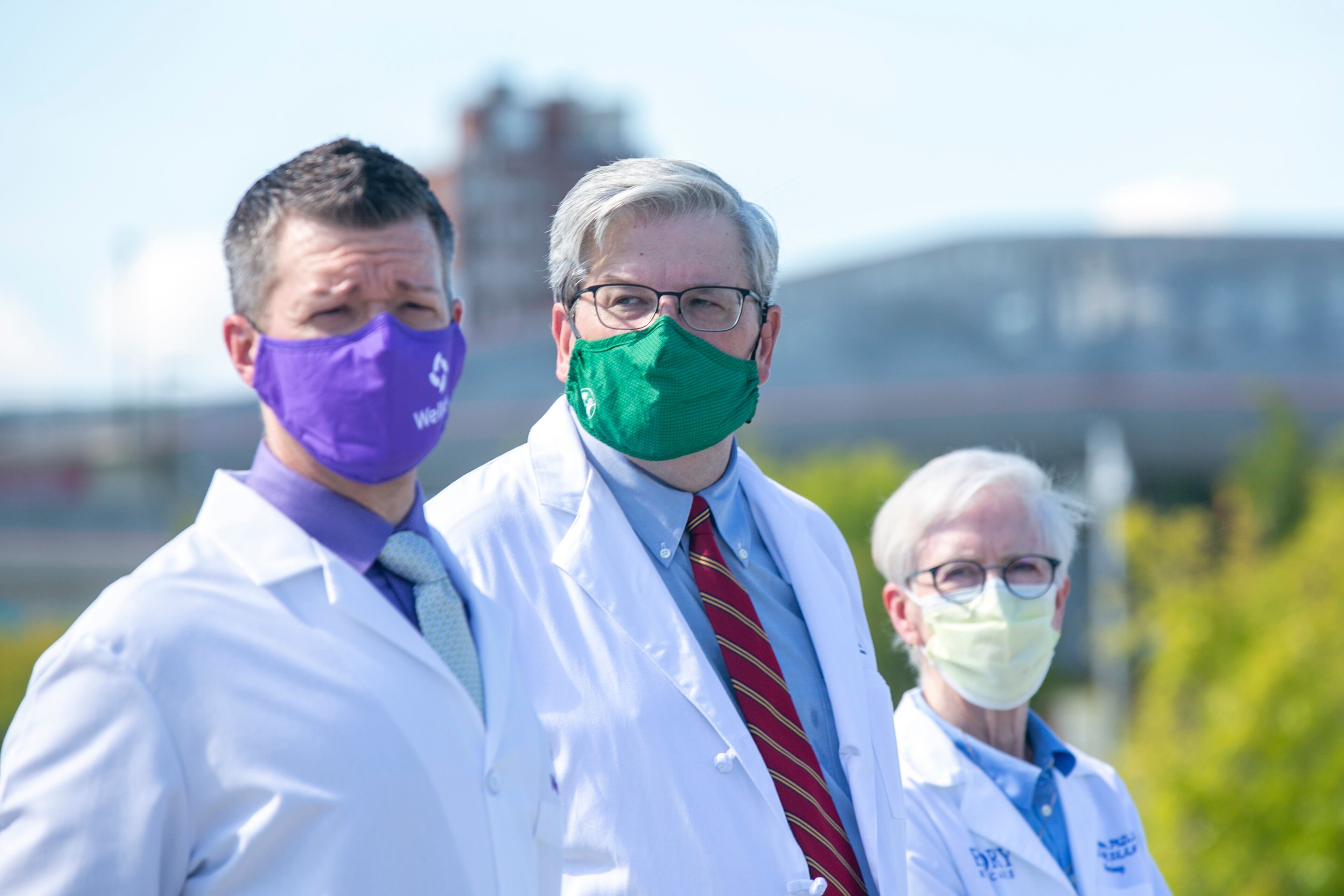 (From left) Dr. Danny Branstetter of Wellstar Health System; Dr. Jim Fortenberry of Children’s Healthcare of Atlanta; and Sharon Pappas, chief nurse executive at Emory Healthcare, listen at a press conference near Mercedes-Benz Stadium in Atlanta, Georgia, on Thursday, August 19, 2021. (Rebecca Wright for the Atlanta Journal-Constitution)