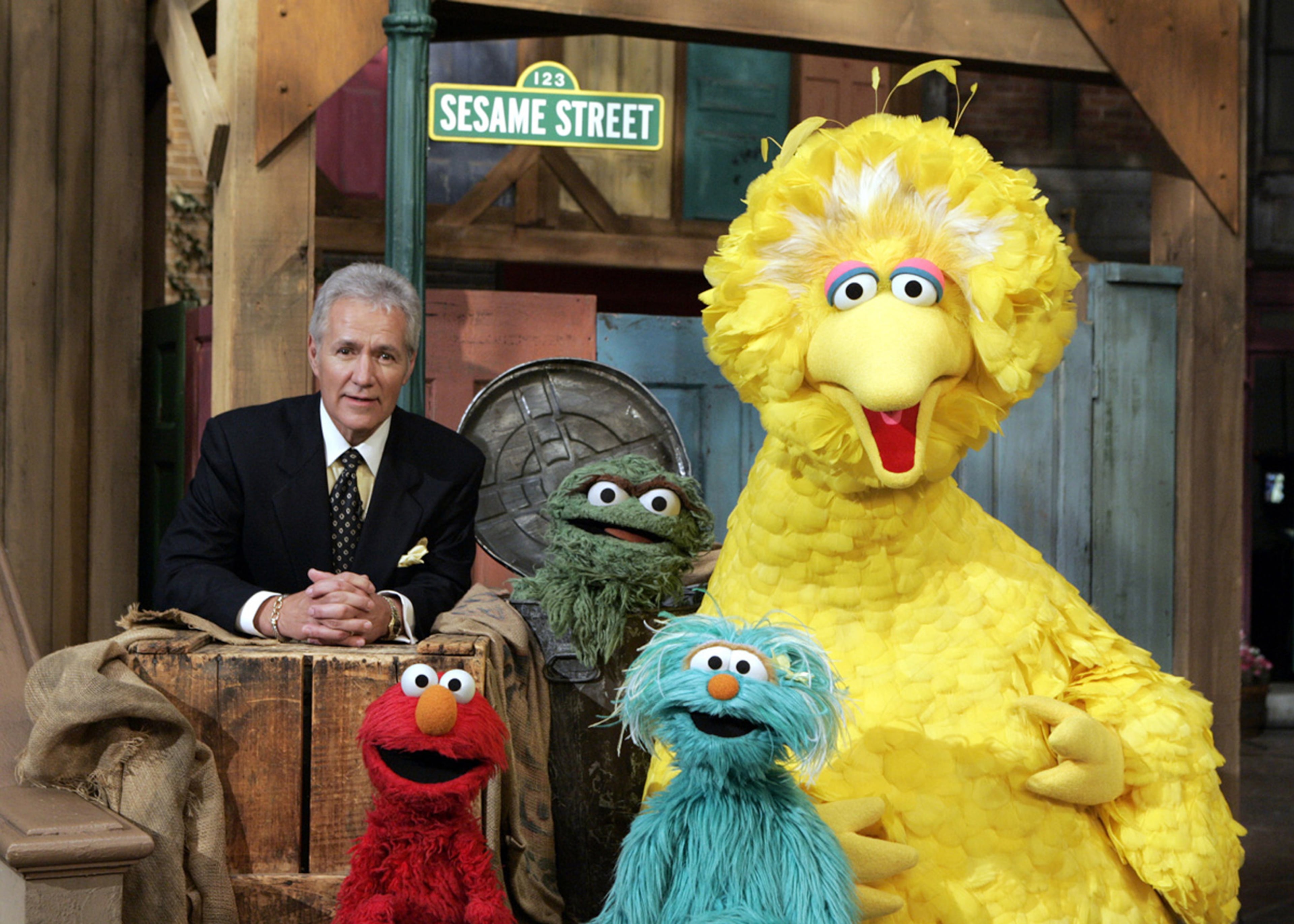 This photo supplied Sesame Workshop shows "Jeopardy" television game show host Alex Trebek posing with some of the Muppet cast of the "Sesame Street" children's television show as they tape an episode on the 37th year of the series, on the set at Kaufman Astoria Studios in New York on Thursday, Nov. 17, 2005.