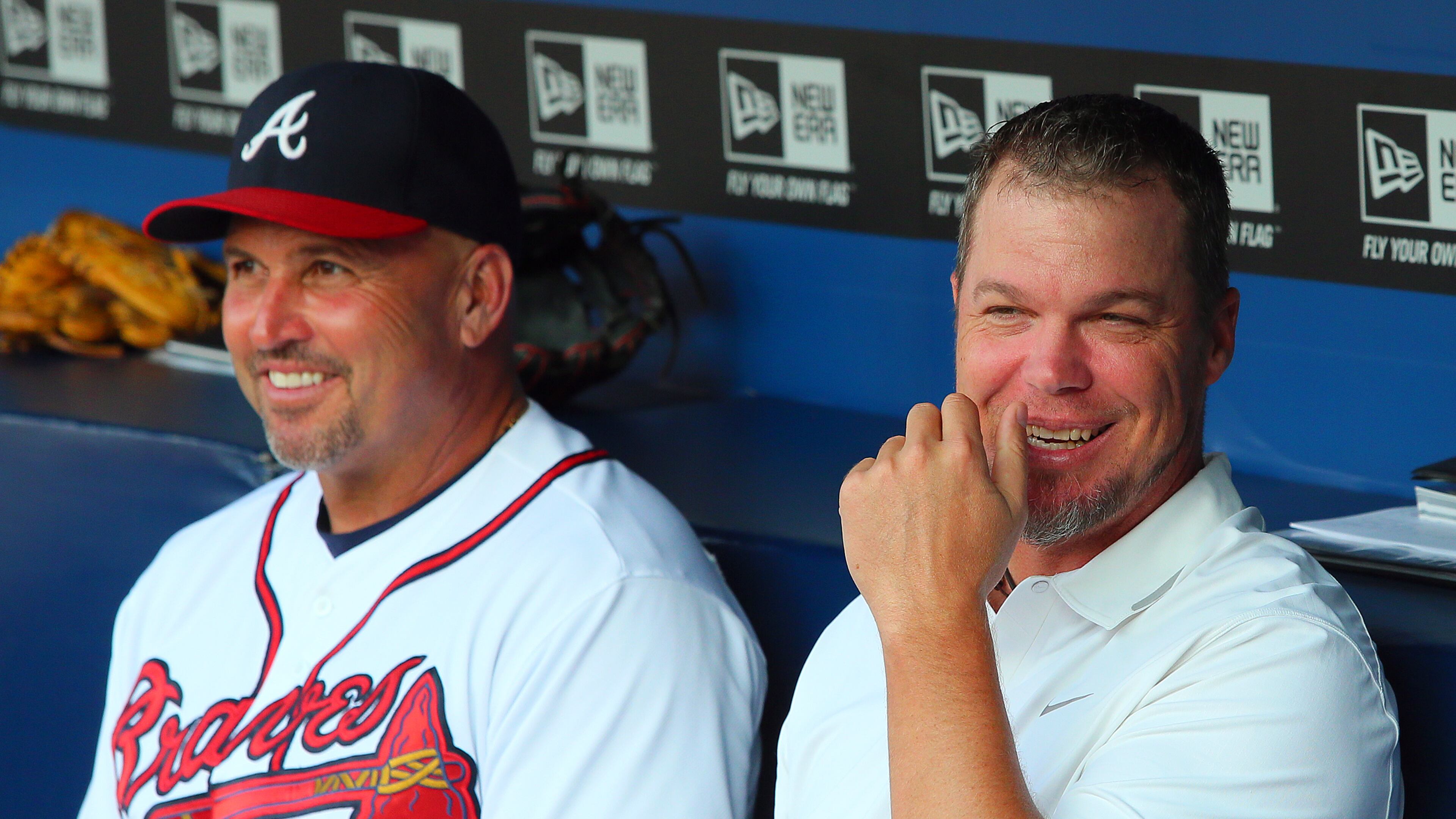 Chipper Jones shares a laugh in the dugout with manager Fredi Gonzalez during a brief visit just before the game against the Cleveland Indians on Wednesday, August 28, 2013, in Atlanta. CURTIS COMPTON / CCOMPTON@AJC.COM