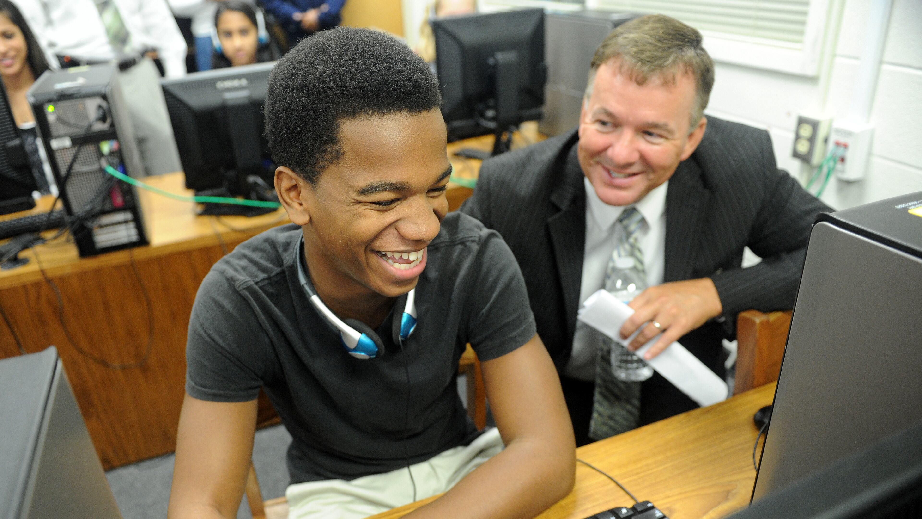 In this 2012 photo, sophomore Malik Miles (From left) shares a laugh with Fayette County Superintendent of Schools Jeff Bearden as he shows him how to do a self-assessment during the official launch of the Microsoft IT Academy at Fayette County High School in Fayetteville.