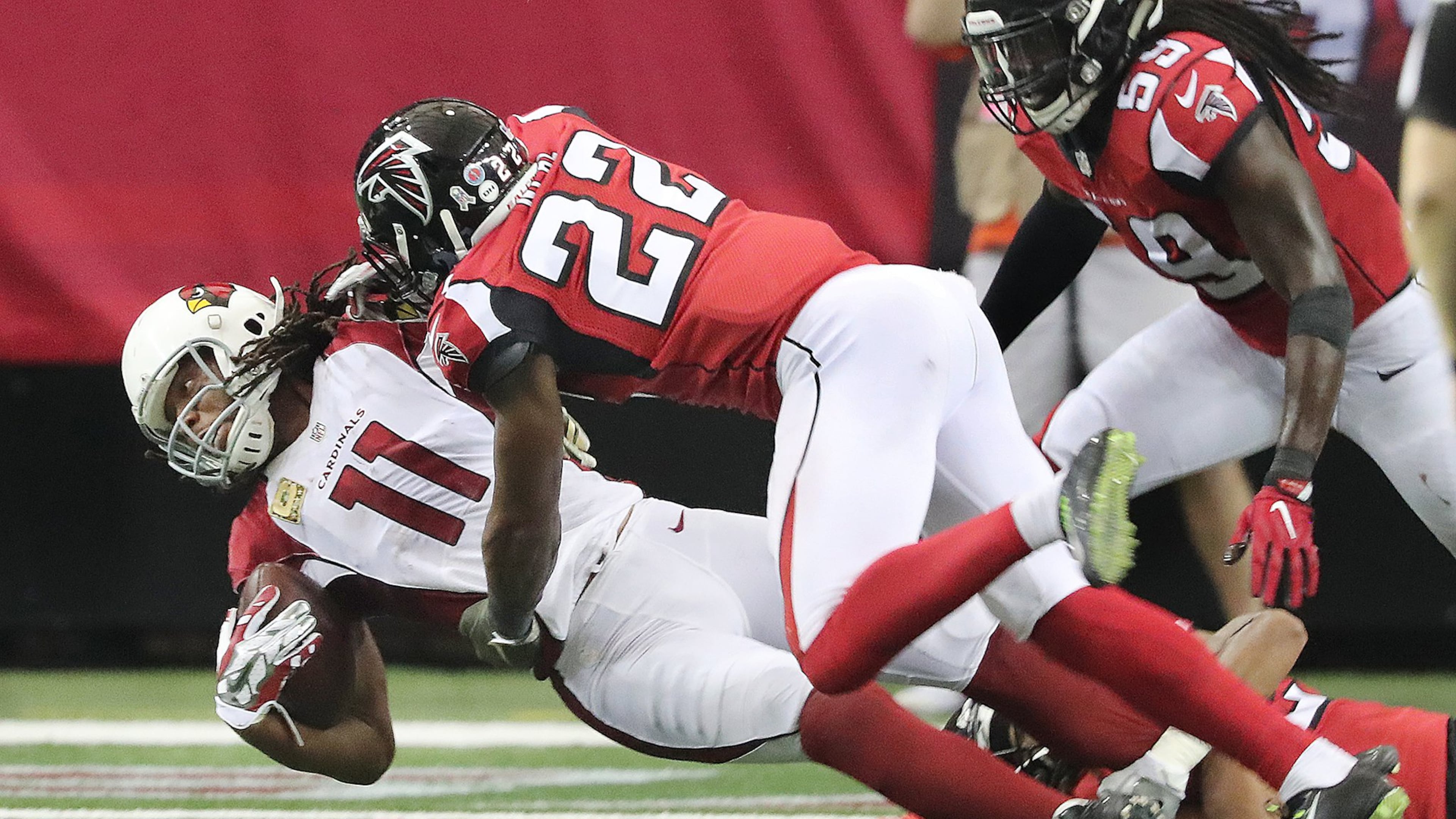 Falcons safety Keanu Neal levels Cardinals wide receiver Larry Fitzgerald with a hard hit during the fourth quarter and is called for a personal foul on Sunday, Nov. 27, 2016, in Atlanta. The Falcons beat the Cardinals 38-19. (Curtis Compton/ccompton@ajc.com)