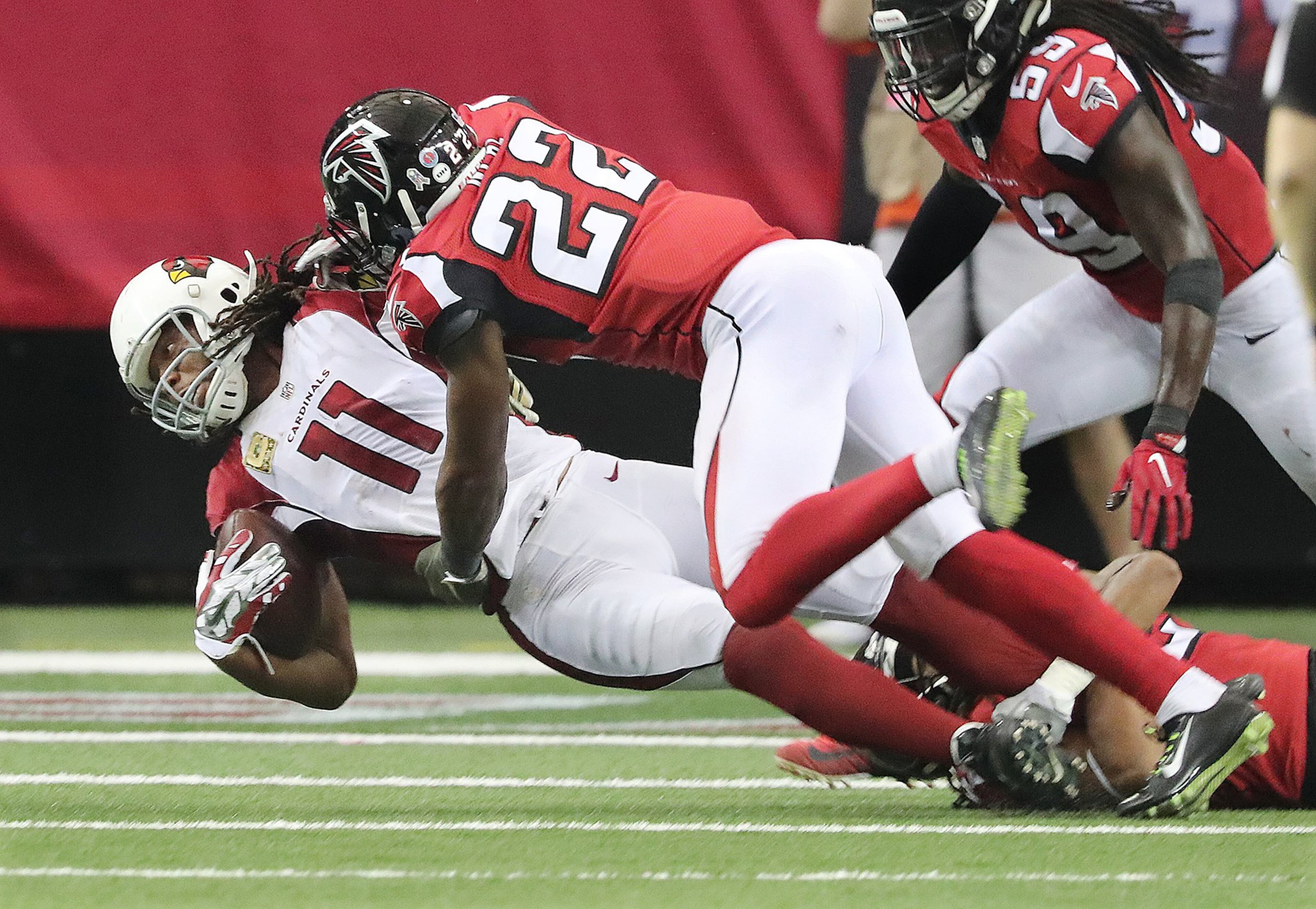 Falcons safety Keanu Neal levels Cardinals wide receiver Larry Fitzgerald with a hard hit during the fourth quarter and is called for a personal foul on Sunday, Nov. 27, 2016, in Atlanta. The Falcons beat the Cardinals 38-19. (Curtis Compton/ccompton@ajc.com)