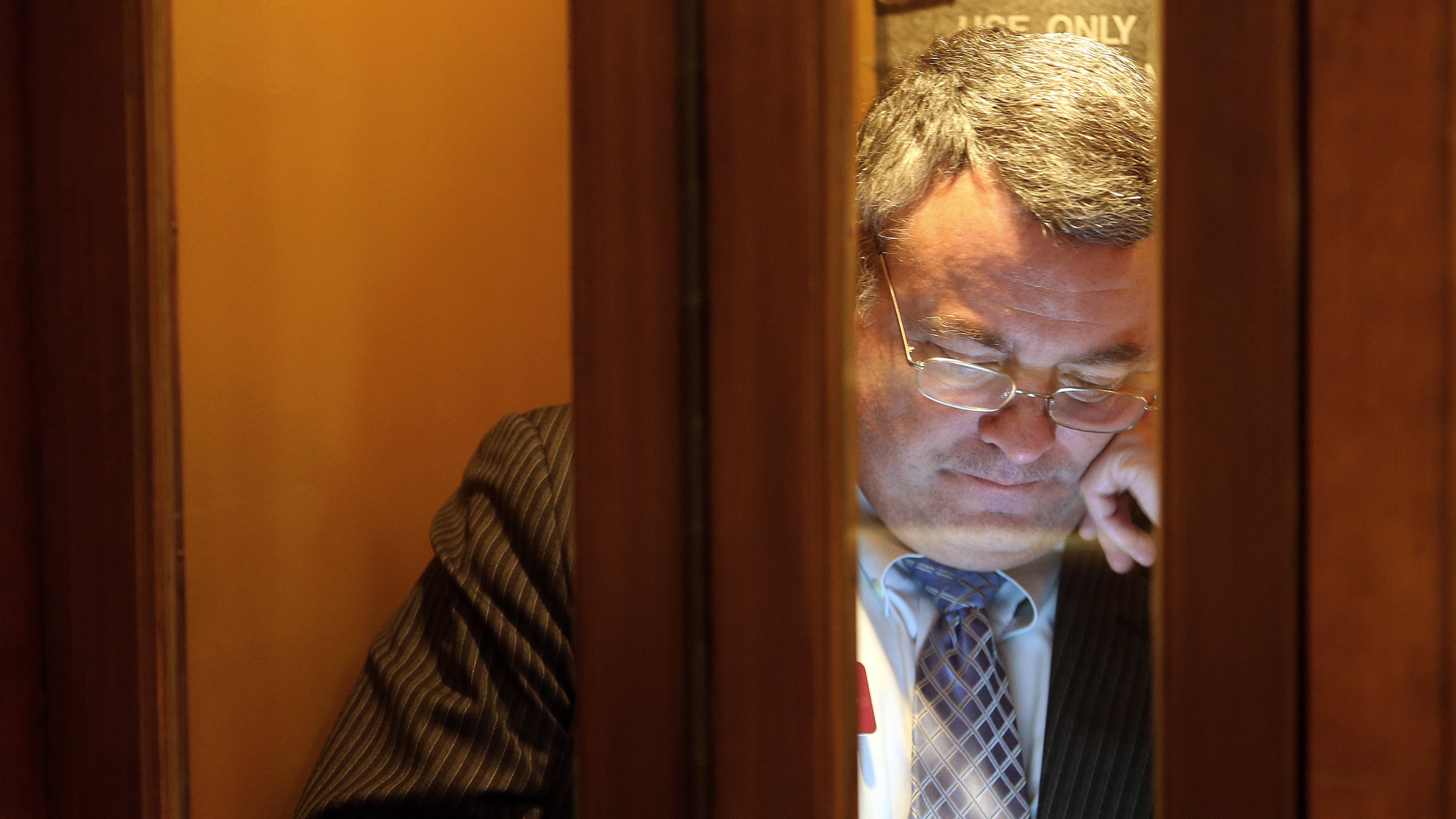 State Rep. Earl Ehrhart, R-Powder Springs, makes use of a phone booth in the House anteroom in this 2014 file photo. Ben Gray, bgray@ajc.com