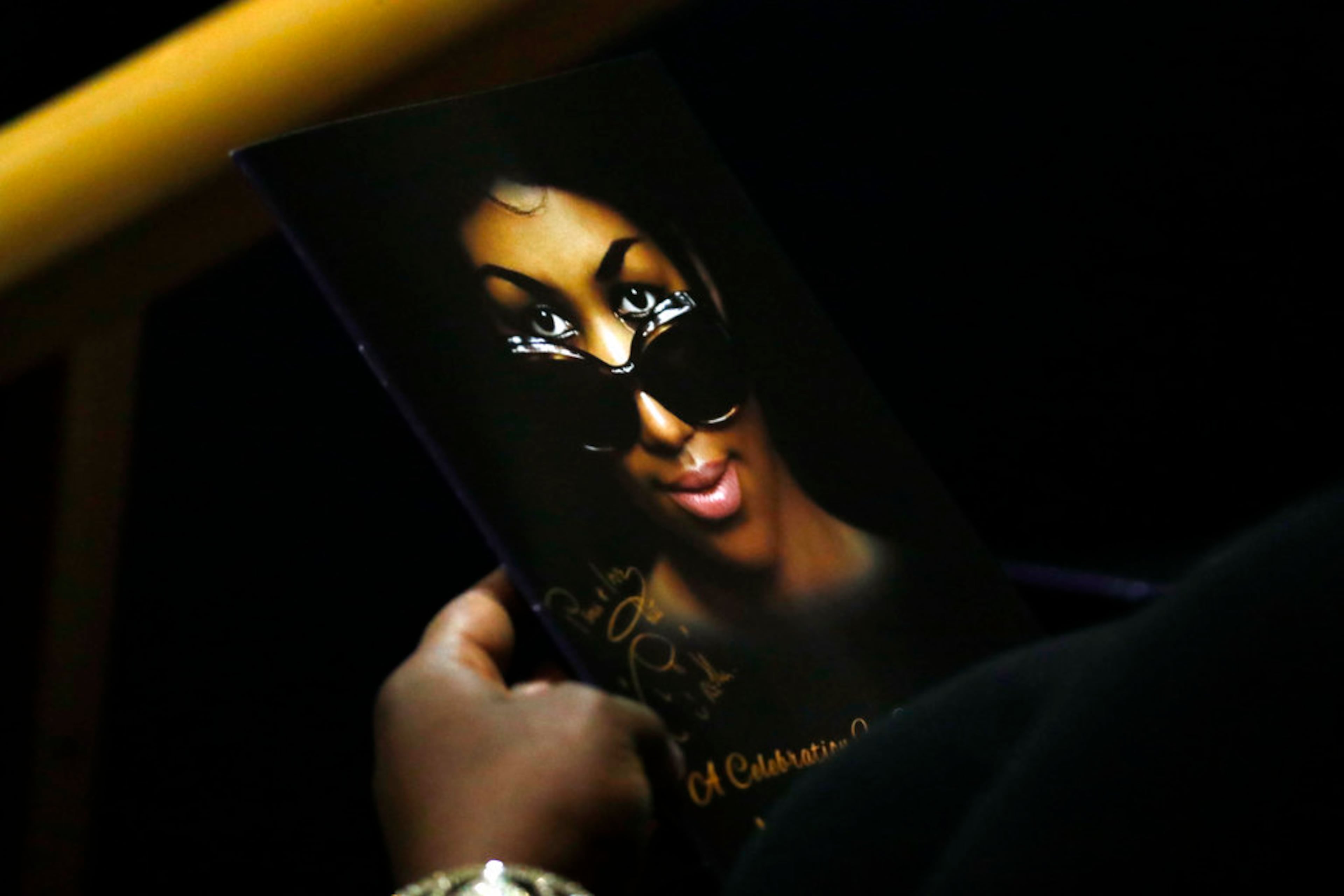A person holds a program during the funeral service for Aretha Franklin at Greater Grace Temple, Friday, Aug. 31, 2018, in Detroit. Franklin died Aug. 16, 2018 of pancreatic cancer at the age of 76. (AP Photo/Paul Sancya)